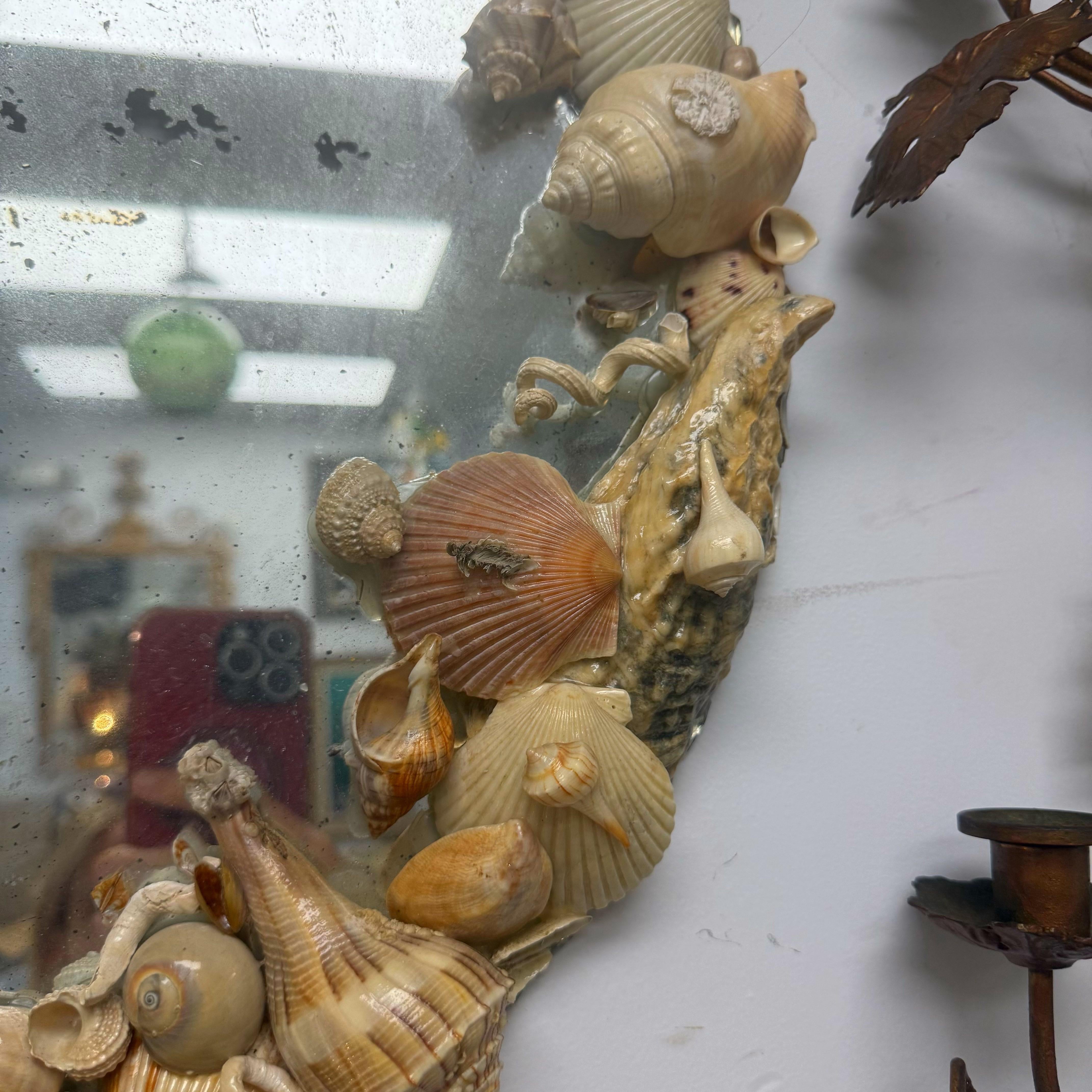 You can see the pretty scalloped edges of the antique mirror.  The natural colored shells have been coated in something to protect them.  This mirror is perfectly imperfect with excellent patina.  No broken shells.  Just a very lovely piece!