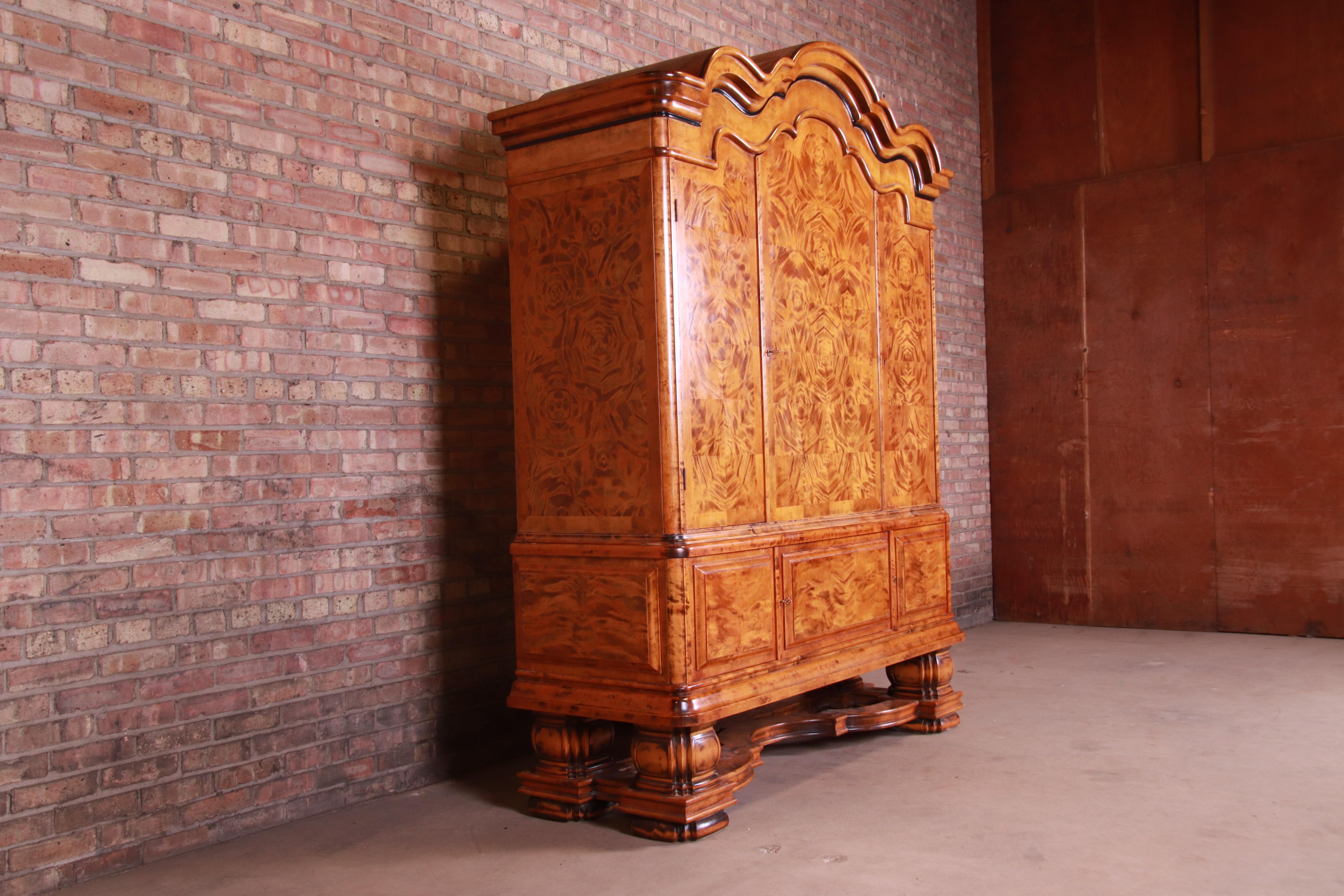 An extremely rare and outstanding monumental Scandinavian Biedermeier armoire, linen press, bookcase, or bar cabinet

By Boman

Finland, 1871

Figural birch, with starburst marquetry.

Measures: 68.75