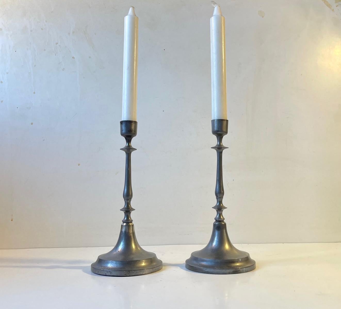 A pair of plain Scandinavian candlesticks in pewter. Very thin delicate stock. Made in Sweden or Denmark circa 1860. Please notice the patina. They have not been polished recently. Please read the condition report as well. They can be fitted with