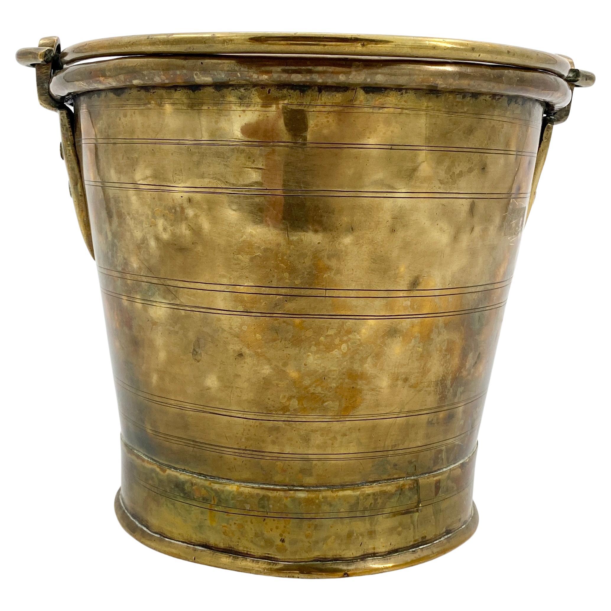 Antique Scandinavian coal or fireplace bucket in Thick Brass, Circa 1810

Scandinavian coal or fireplace bucket with its original patina. It dates back to circa 1800. Hand forged brass handle, rivets, inner pewter lining and a honest and