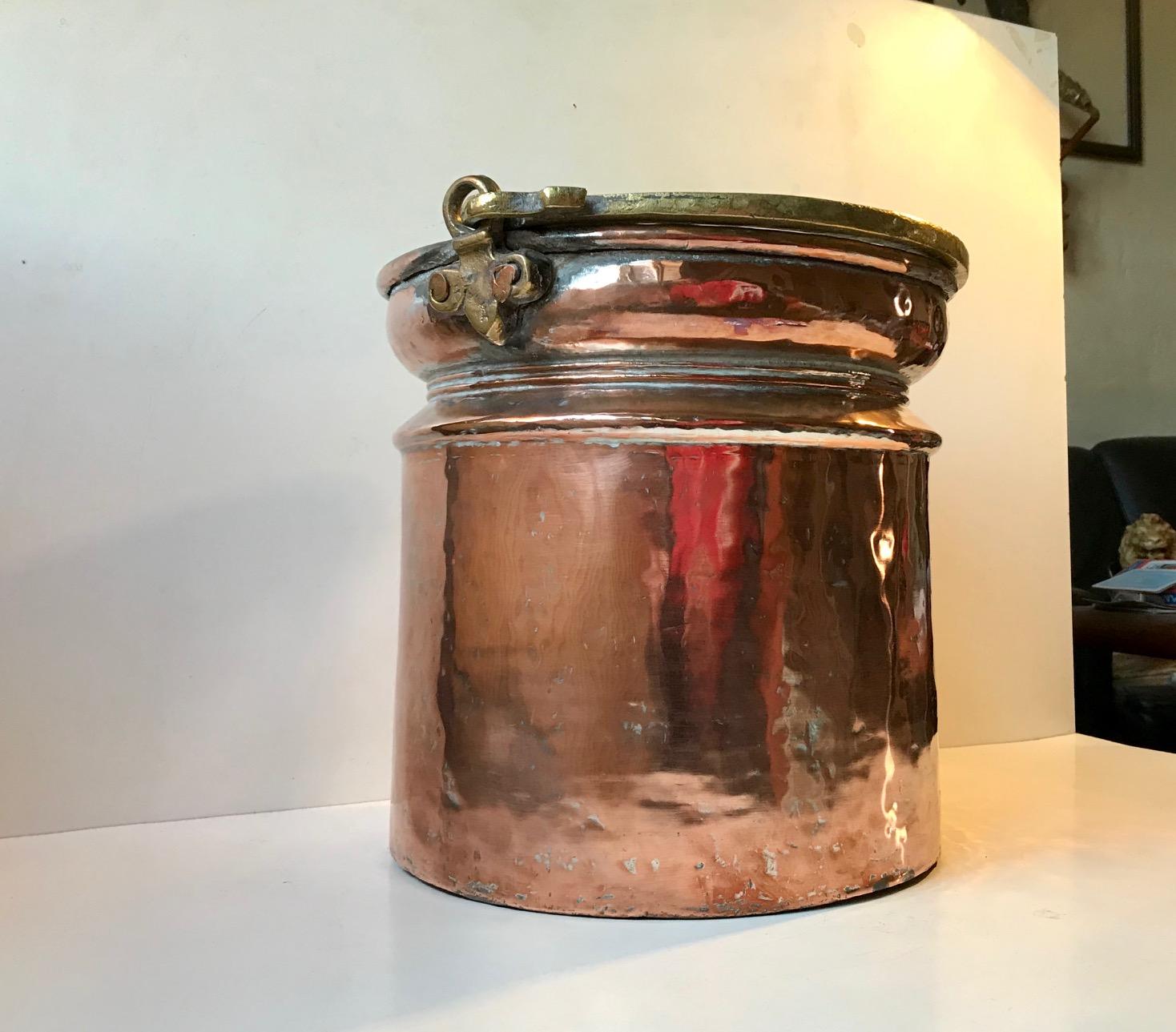 A fine quality Scandinavian (probably Swedish) coal or fireplace bucket. It dates to circa 1750. Perhaps a tat earlier. Finely hand forged brass handle, rivets, inner pewter lining and a honest ware with a rosy silvery patina. The height of 26.5 cm