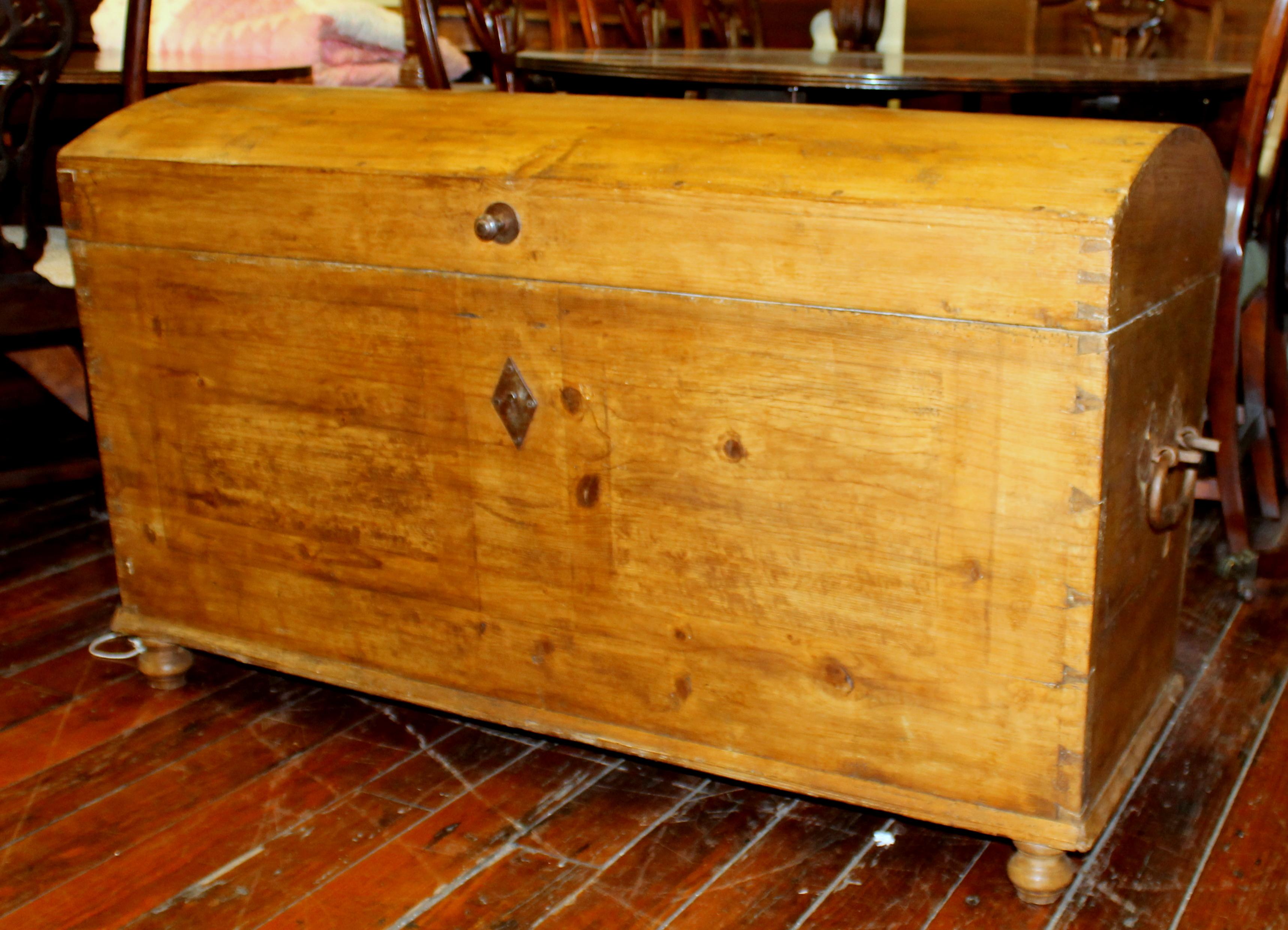 Very rare antique Scandinavian pine very larger deacon's dome-top trunk with fitted interior hinged box and wonderful, original strap iron hinges, cast iron carrying handles and nail head studs. Antique paper lining still remains in lid of trunk.