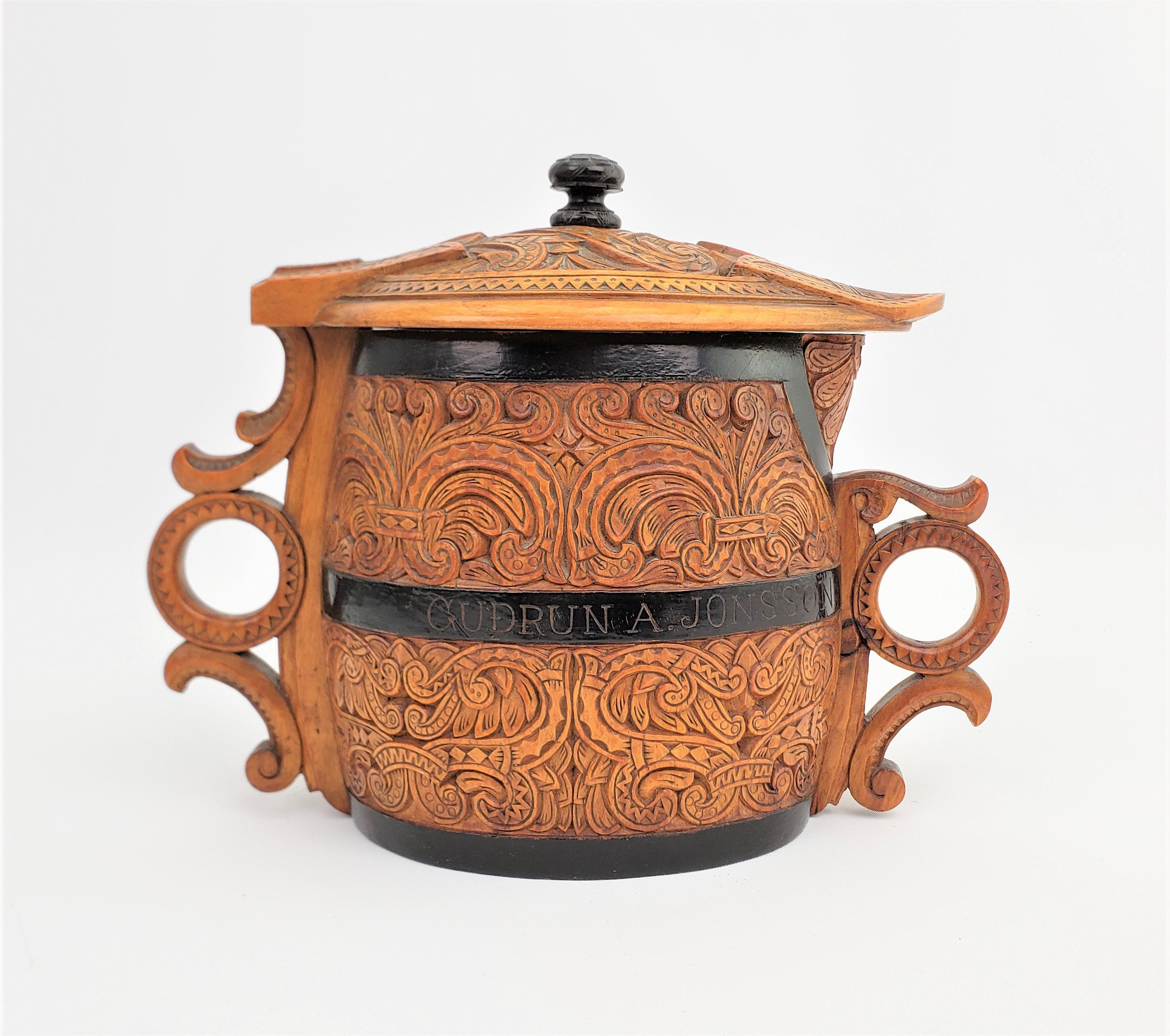 This antique hand-carved wooden folk art pitcher is unsigned, but presumed to have been made in Scandinavia, likely Denmark, is approximately 1890 in a period Folk Art style. The pitcher is done in a softwood which has been carved in an oval shape