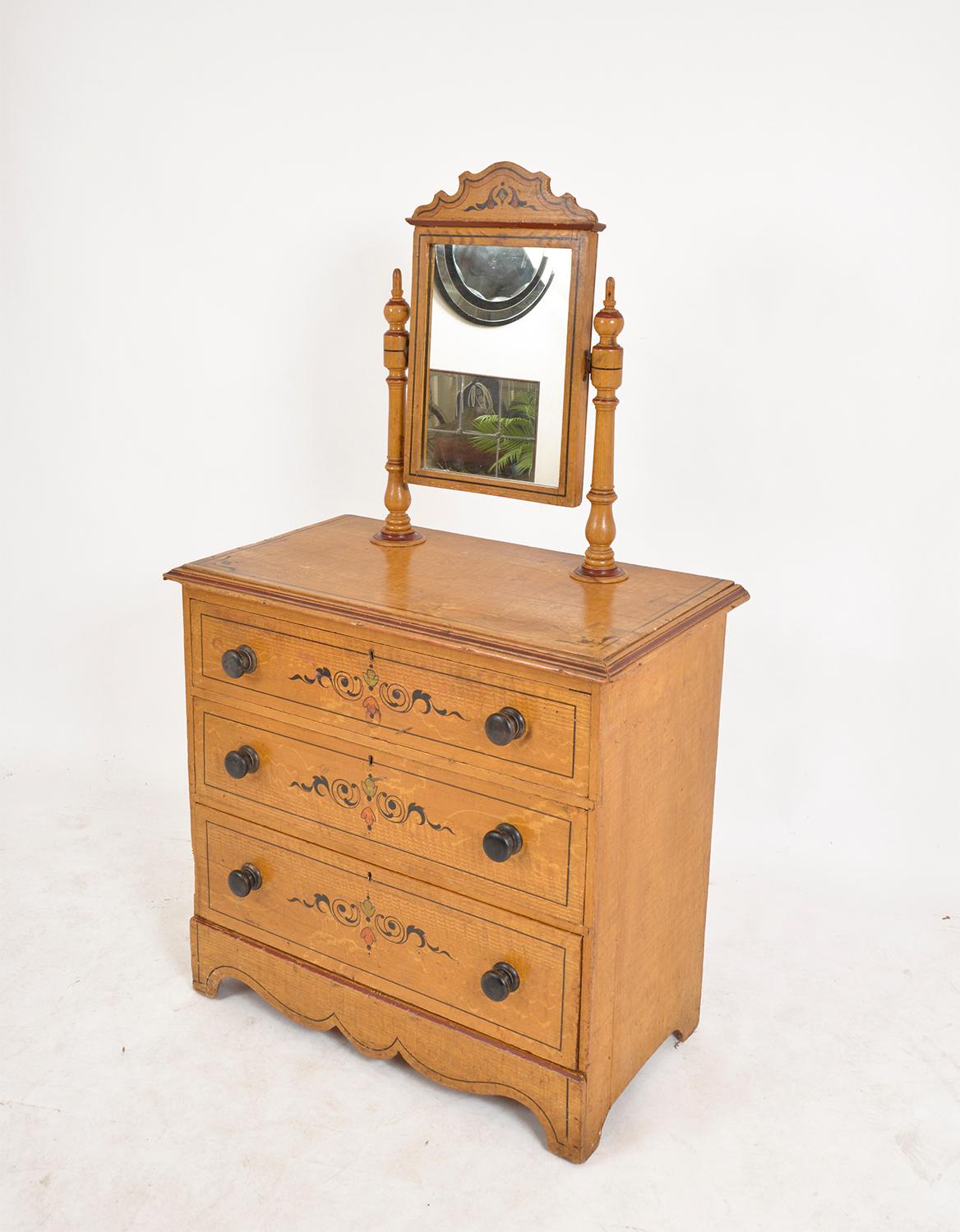 A very decorative English pine dressing chest of three drawers with an attractive honey hue and contrasting ebonized knob handles, surmounted by a dressing-glass, which can be easy removed if preferred as a chest of drawers. Retaining the original