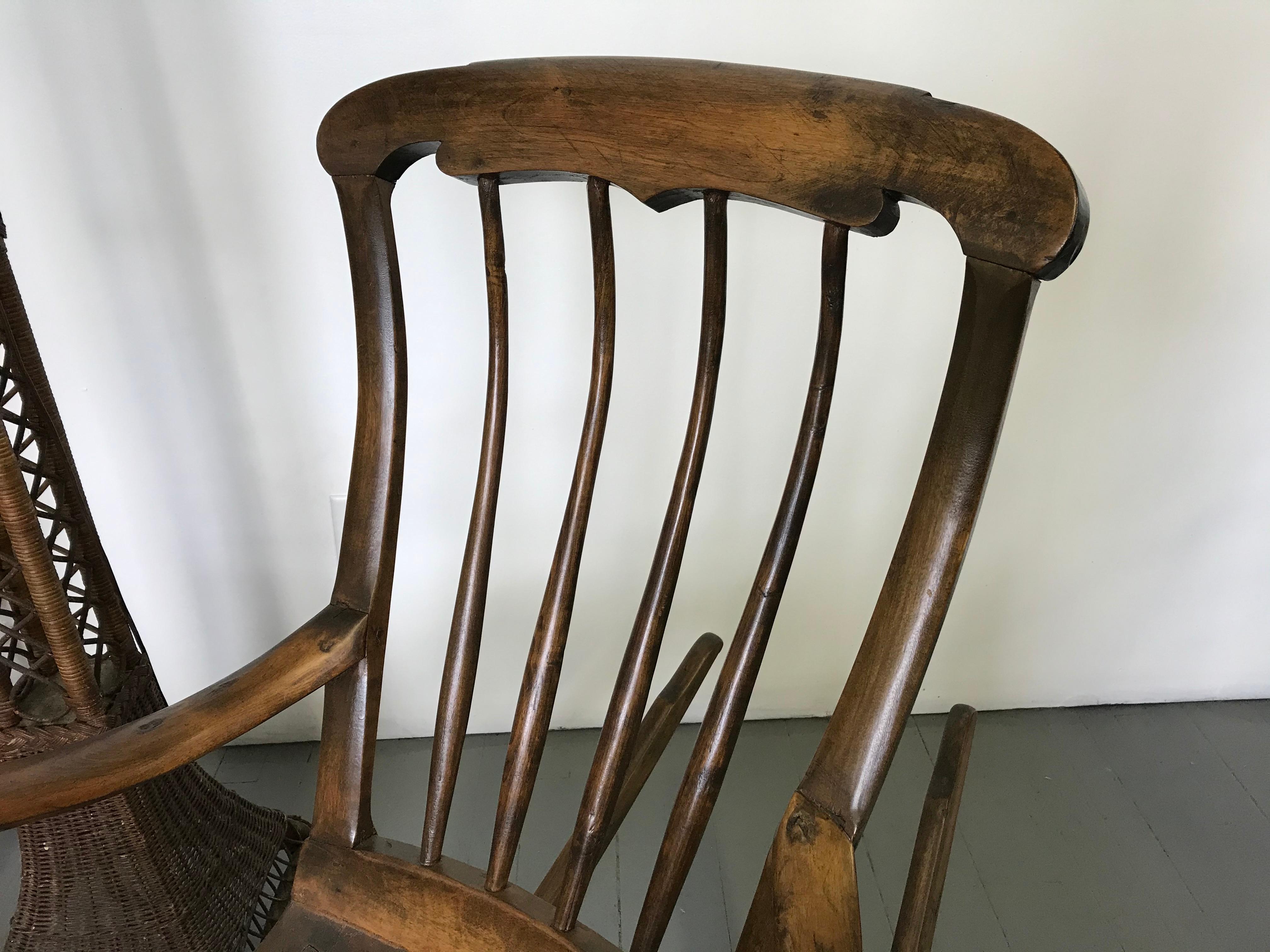 Remarkably original artisanal handcrafted rocking chair from Sweden circa 1840-1850. Stained birch wood. Entirely handmade. All joints are pegged and doweled. Splats and rails were steam bent. Seat boards hand planed. Arm supports are so organic and