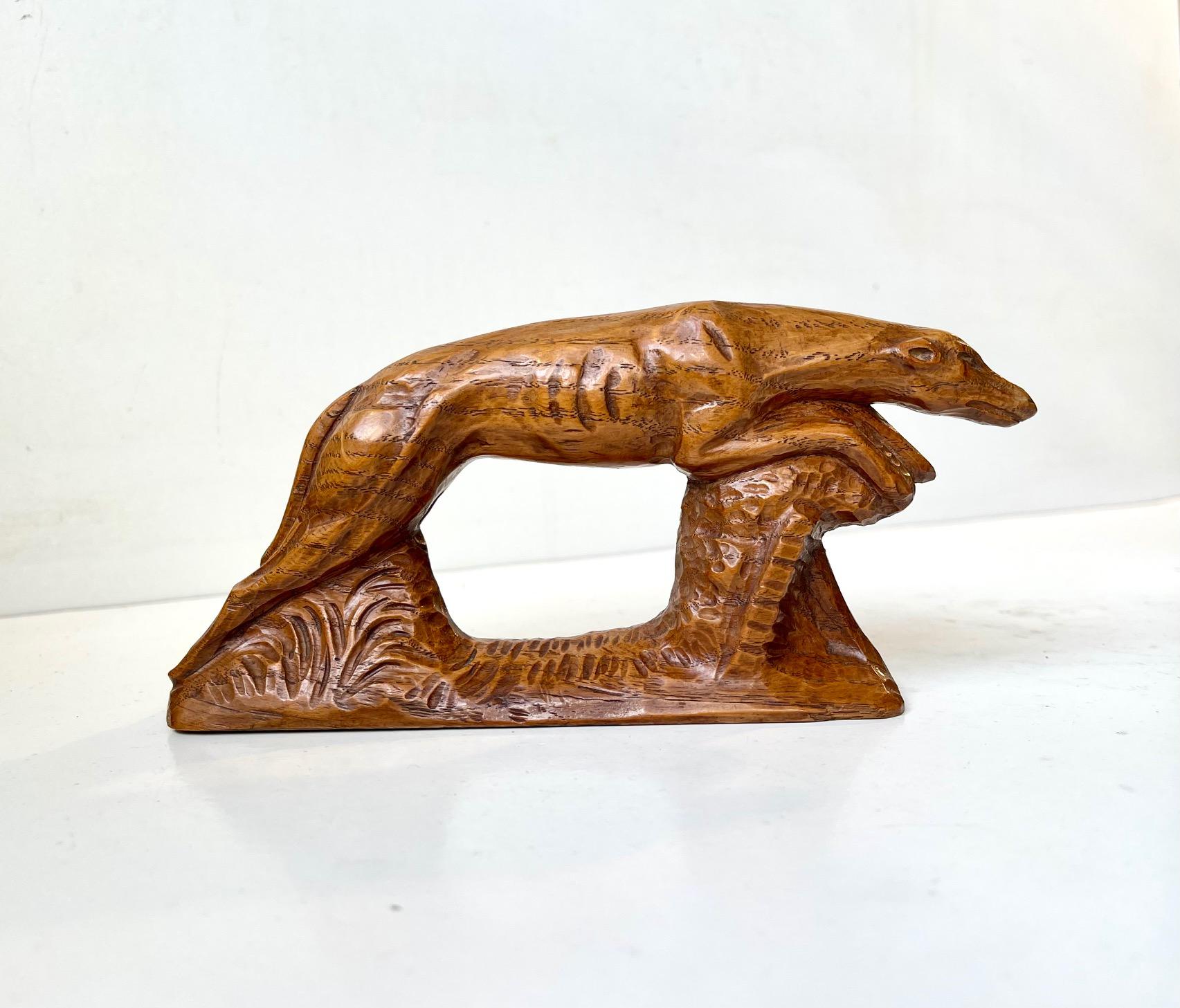 A skillfully hand carved figurine of a running Greyhound or Whippet. Beautiful details and a rich golden patina to the oak. Made by an anonymous craftsman in Scandinavia circa 1900-20. Measurements: W: 18.5, D: 4, H: 9 cm.