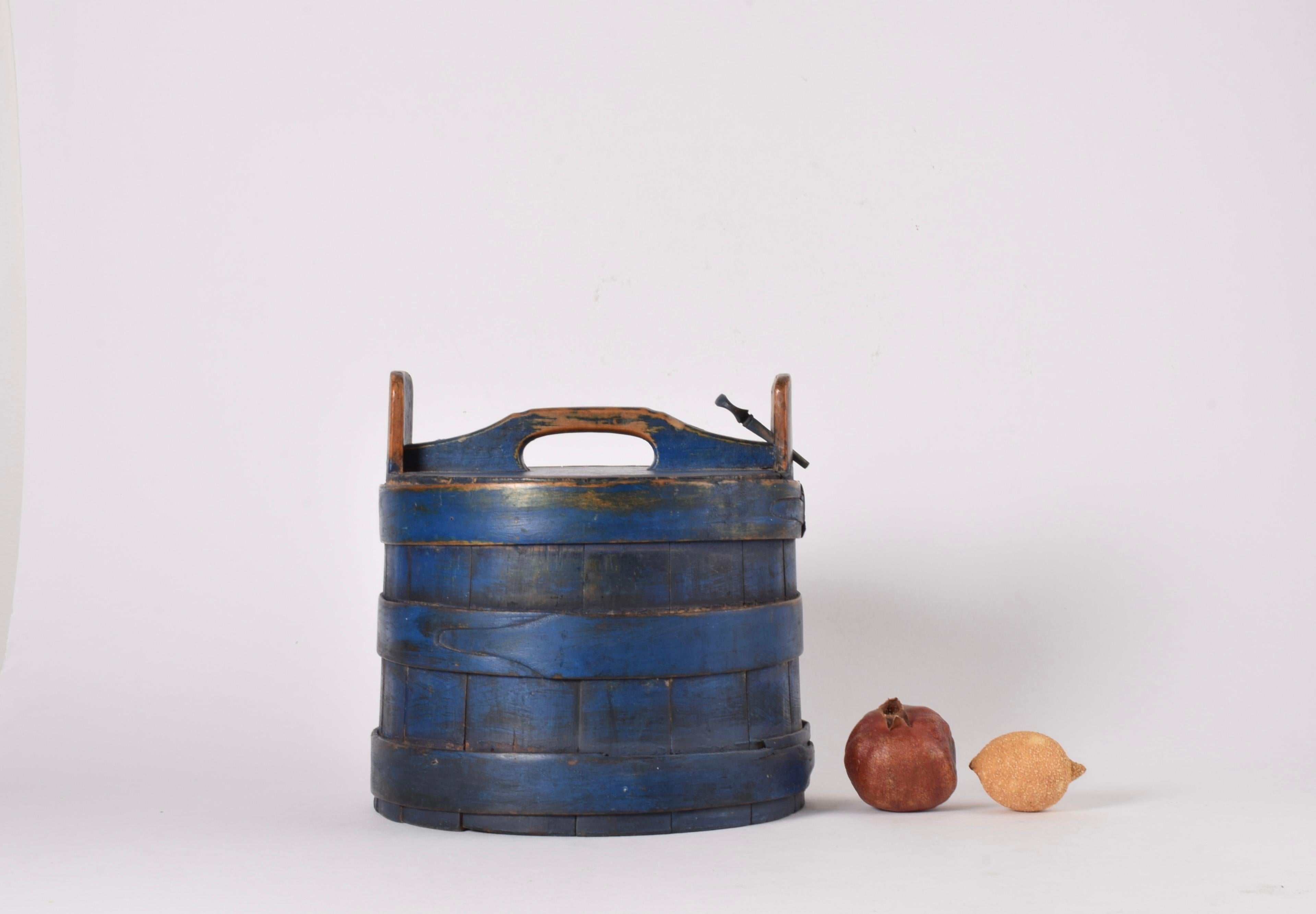 Antique Scandinavian wooden container with original blue paint. 
It´s most likely from Sweden and most likely made around 1850. 

We suppose it has been used for storage of food. It has a closing mechanism so you can use the handle when transporting