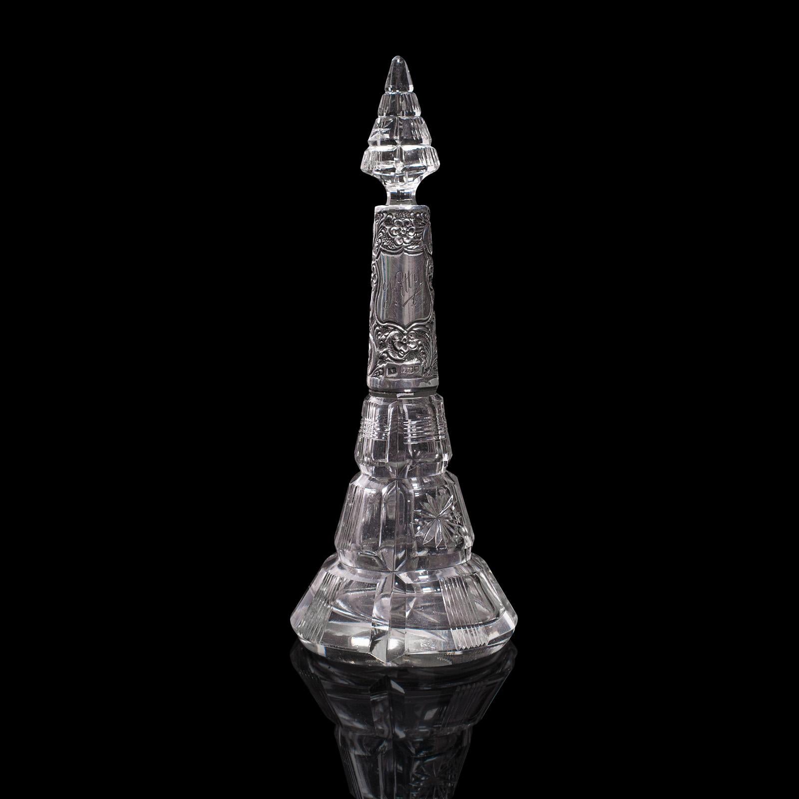 This is an antique scent bottle. An English, glass and silver perfume bottle, with London hallmark, dated for 1912.

Wonderfully presented, with Art Nouveau overtones
Displays a desirable aged patina and in good order
Cut glass with a clear,