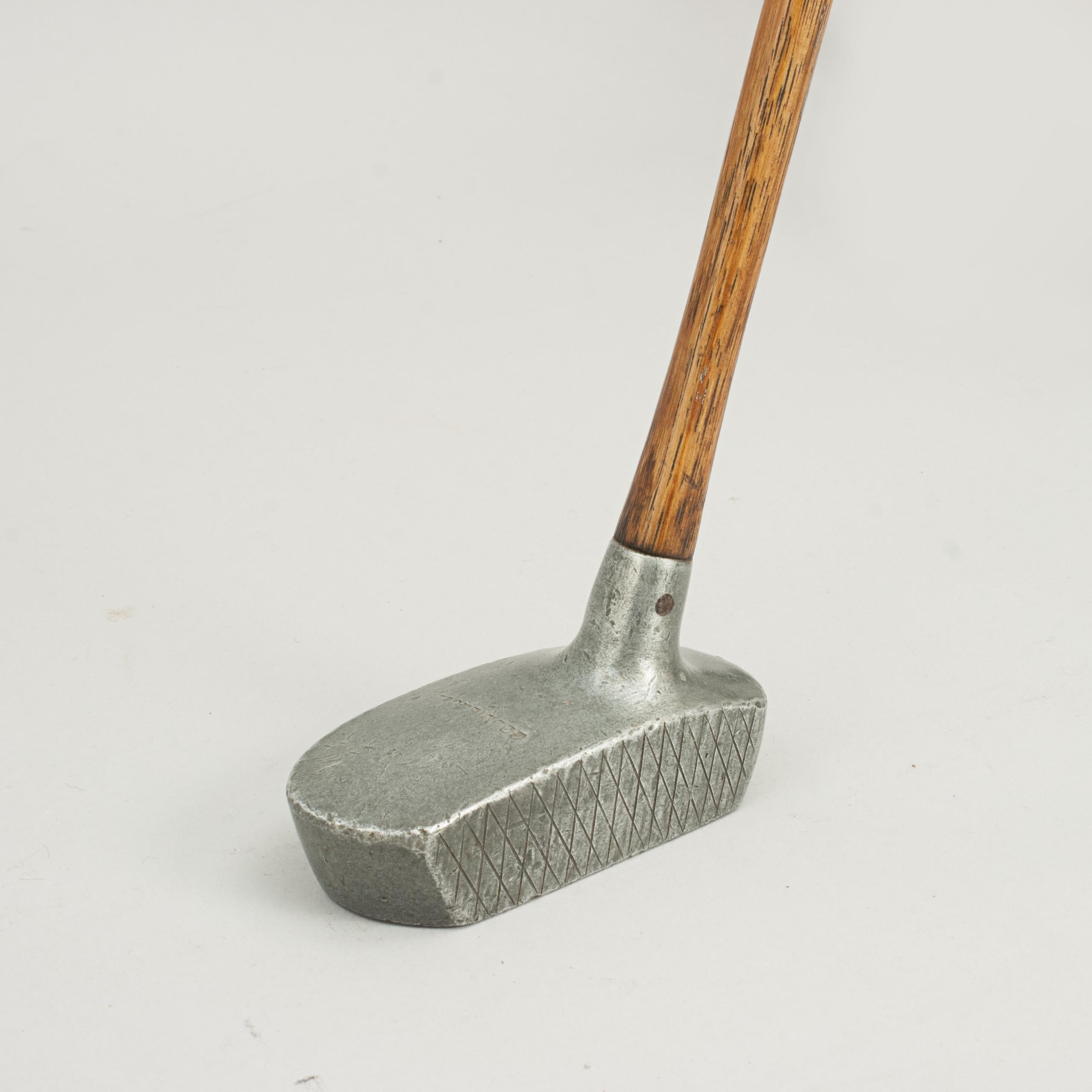 Aluminium Center Shafted Putter, Goodie & Co.
A good example of an aluminum Schenectady type putter by Goodie & Co. The top of the head is stamped 'Goodie & Co.', face with X scoring. The club is in good original condition, with a hickory shaft