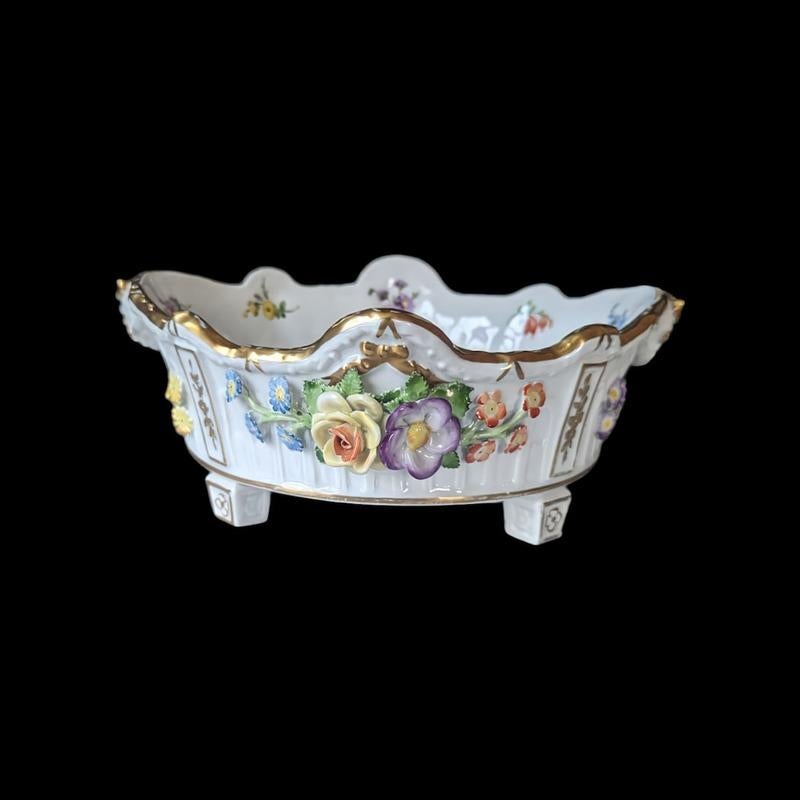 This elegant Von Schierholz porcelain floral bowl showcases the timeless beauty and craftsmanship of 19th-century German porcelain. The bowl is adorned with meticulously hand-painted floral motifs in vibrant hues of pink, blue, and green, creating a