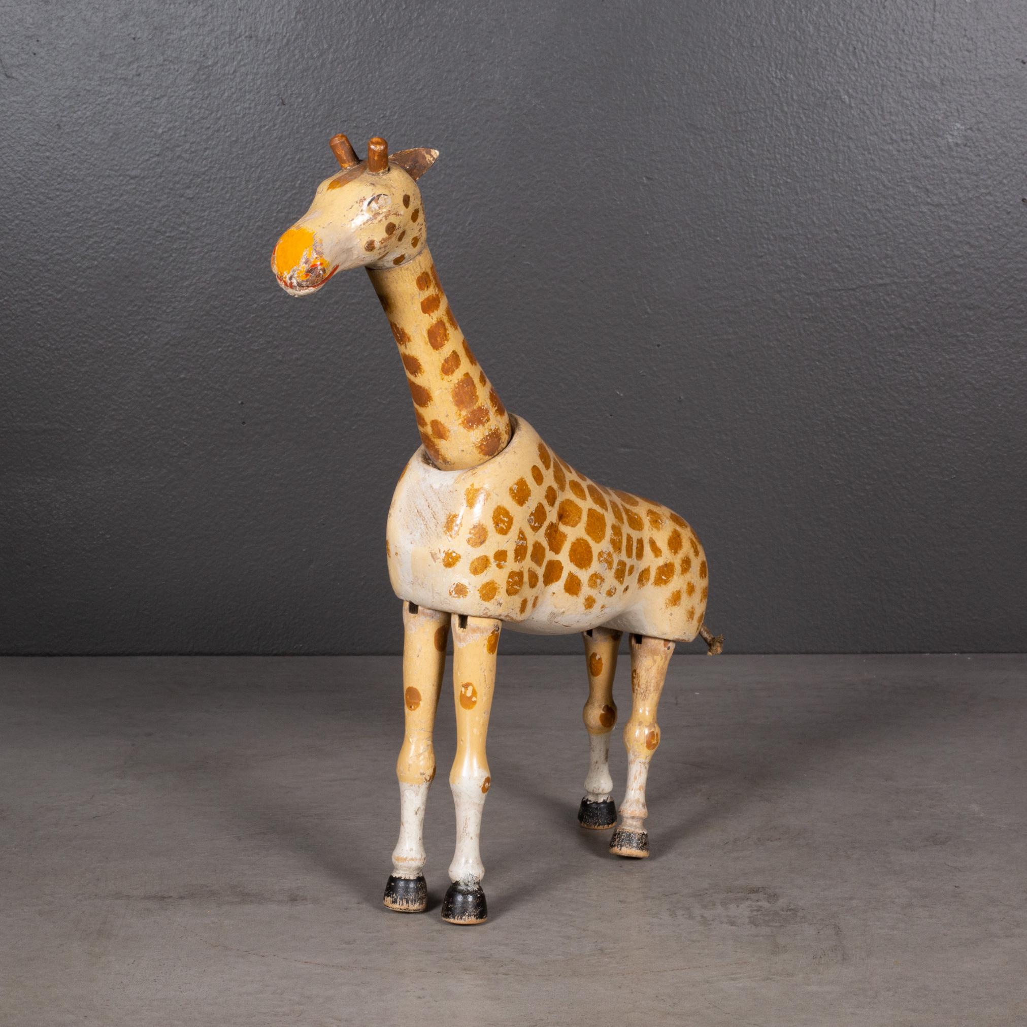 ABOUT

Jointed wooden giraffe manufactured in the 1900s by the Schoenhut Piano Company as part of the Humpty Dumpty Circus collection. Made from carved wood with original hand painted finish and articulated joints for posing. Glass eyes and leather