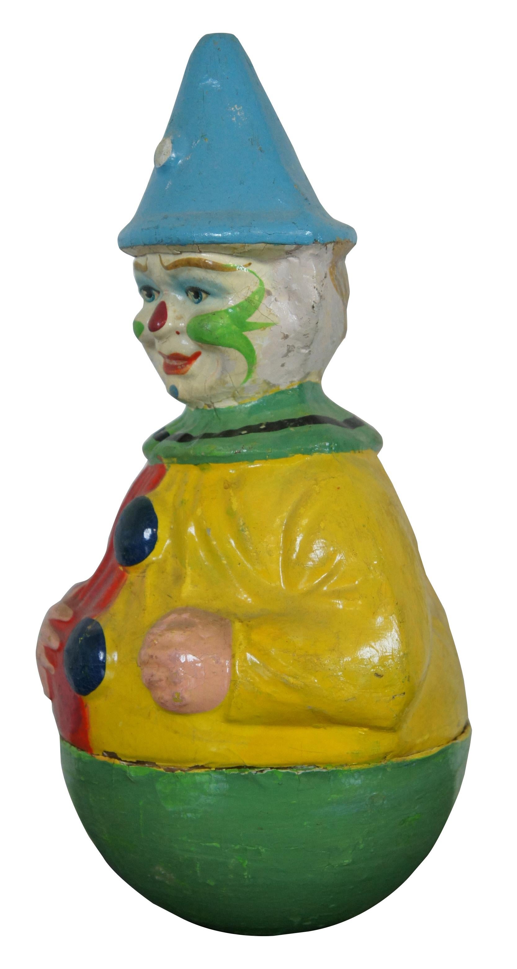 Antique German papier mâché roly poly clown toy by Schoenhut. Measures: 12”.
  