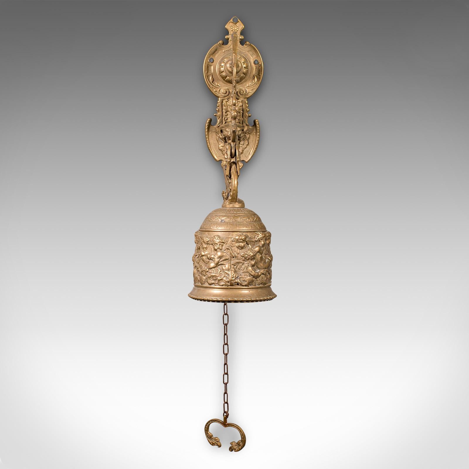 This is an ornate antique school bell. A Continental, brass wall mounted chime, dating to the late Victorian period, circa 1900.

Endearingly fascinating bell with superb detail throughout
Displaying a desirable aged patina and in good order
Warm