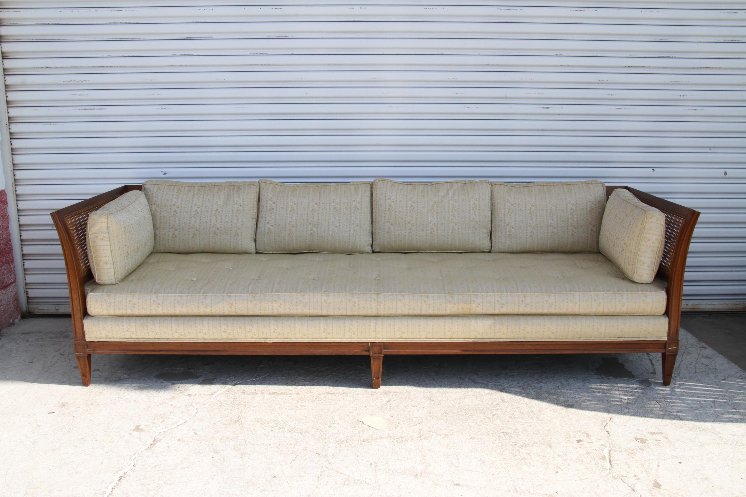 Antique Schoonbeck Company Cane Sofa features cane back and sides and tapered legs. Upholstery was redone some years ago but still in good condition. Caning is in near perfect condition. Structurally in excellent condition, including springs and
