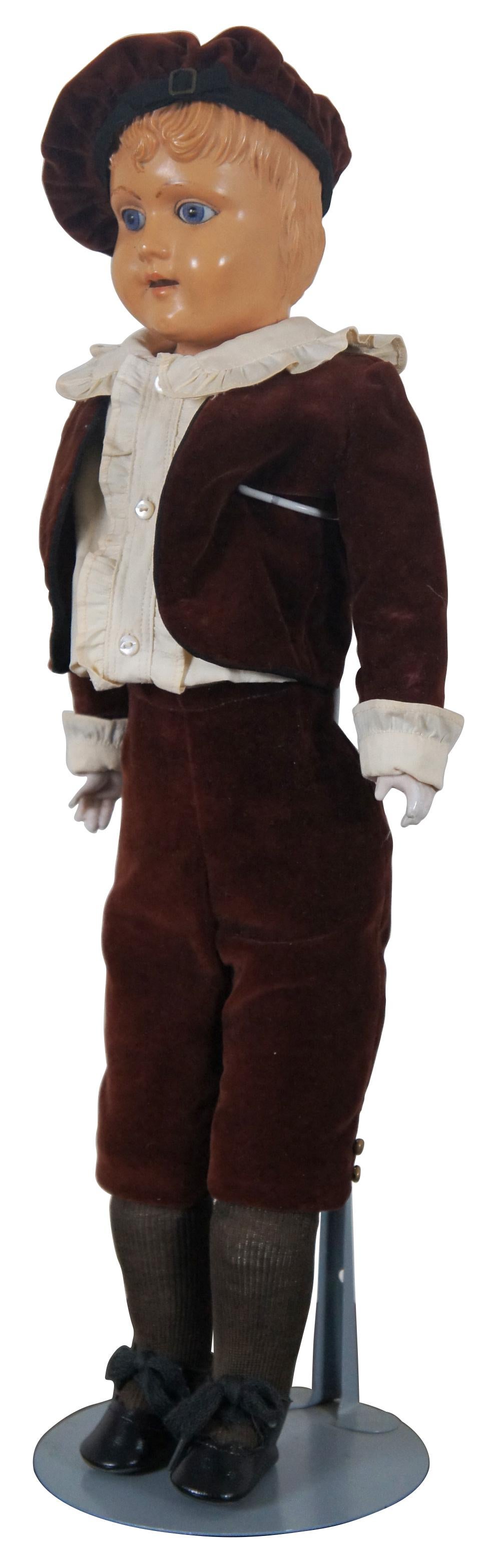 Circa 1903 antique doll by Schutz-Marke Germany with celluloid head and jointed leather body, composite hands and dressed in a burgundy leather suit and Scotch bonnet. “In 1889, a German company had found a way to improve celluloid so it could be
