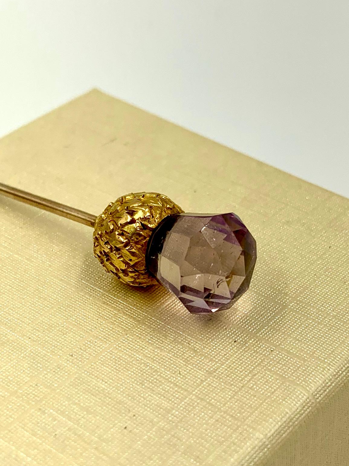Naturalistically modelled faceted amethyst and 14K yellow gold thistle pin, Scottish, 19th century.
The Thistle flower is symbolic of graciousness and nobility in Celtic lore. It became the emblem of Scotland in the thirteenth century and is the