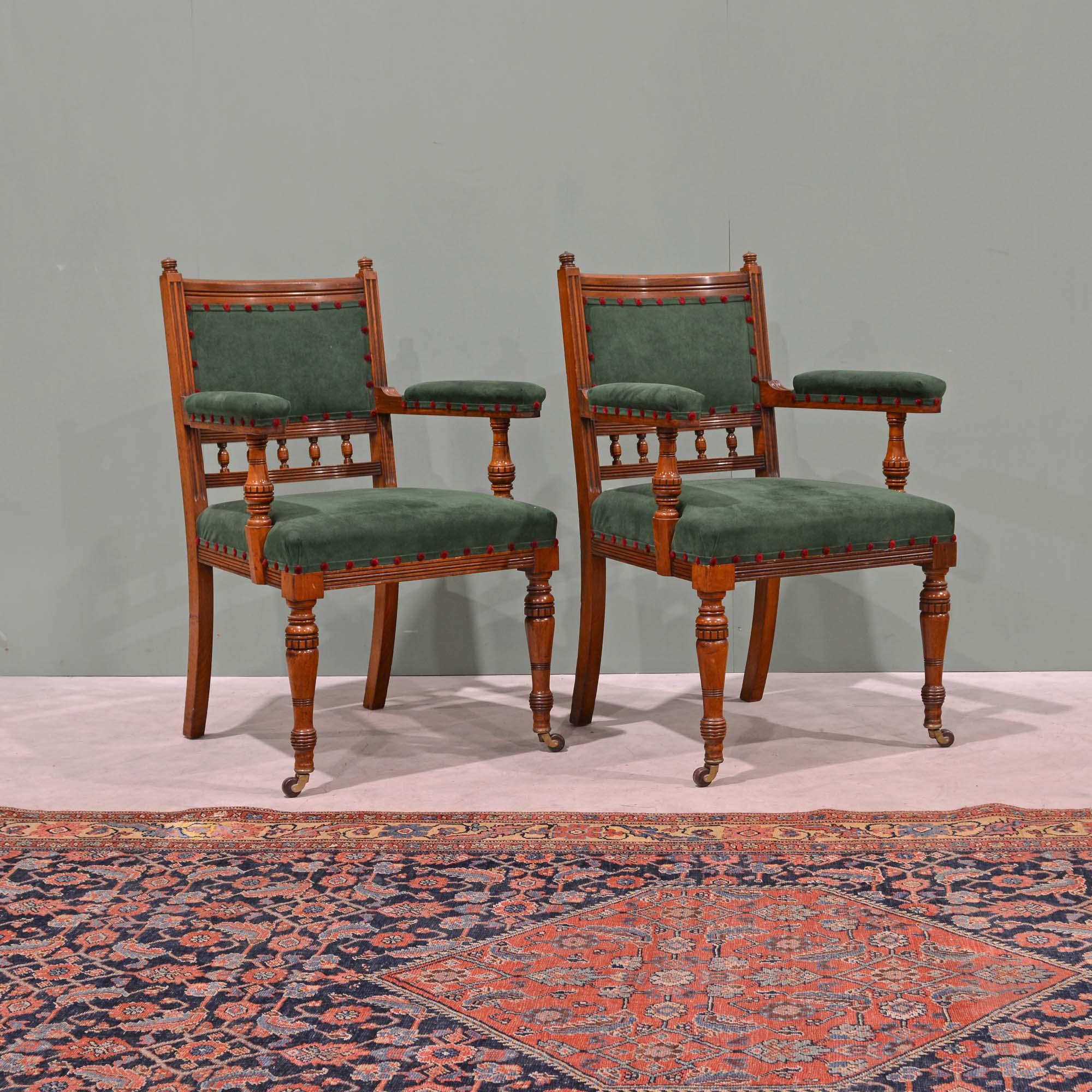 A pair of  Scottish 19th century walnut armchairs by J. & T. Scott, Edinburgh of the best quality. Made in the Aesthetic style, the backs with turned finials, moulded and polished cresting rail and padded upholstered backs over a row of turned