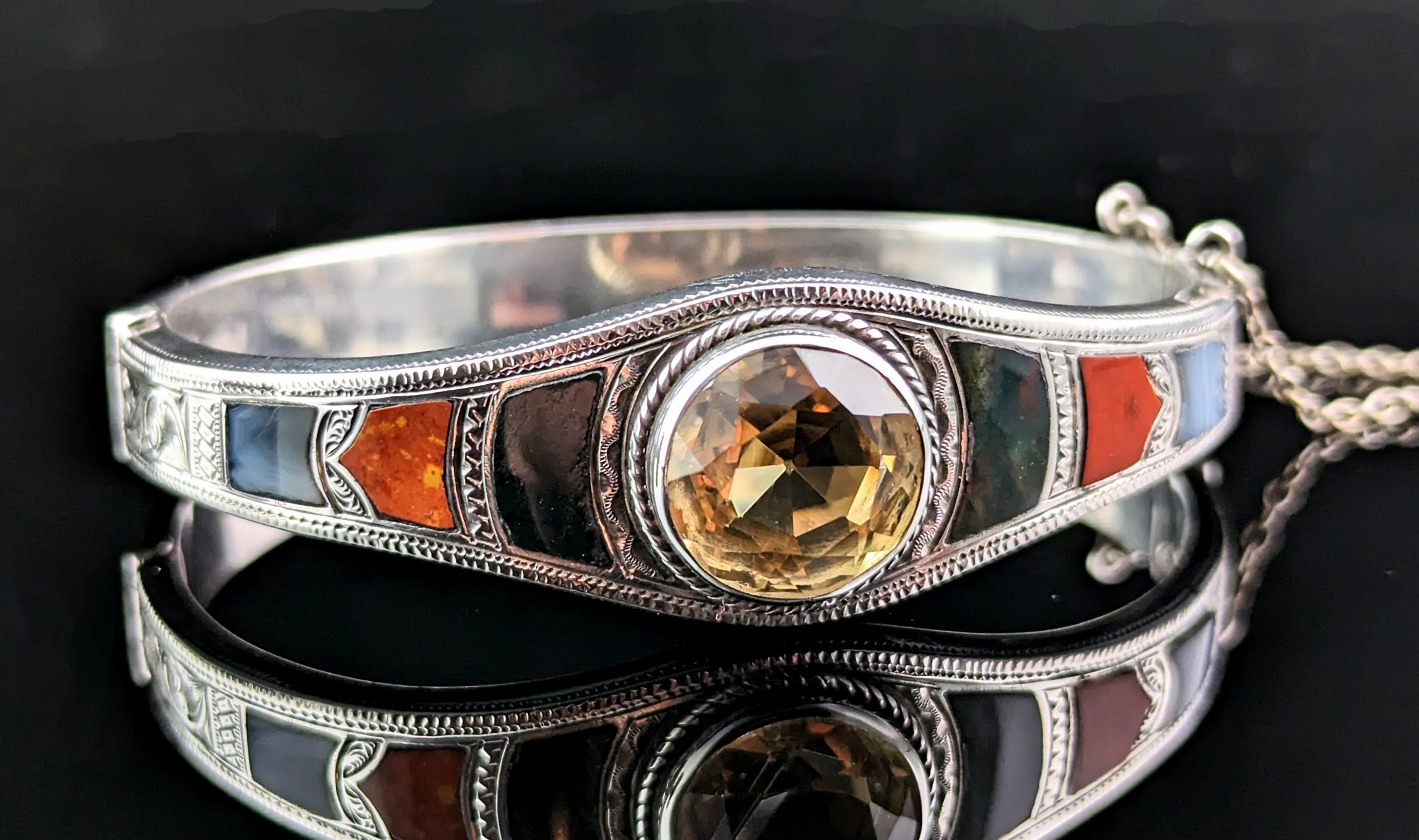 This rare antique Scottish Agate and citrine bangle is really something else!

The bangle is crafted in cool sterling silver, finely engraved to the front section and set with various beautiful Scottish Agate slabs including Bloodstone, Red Jasper