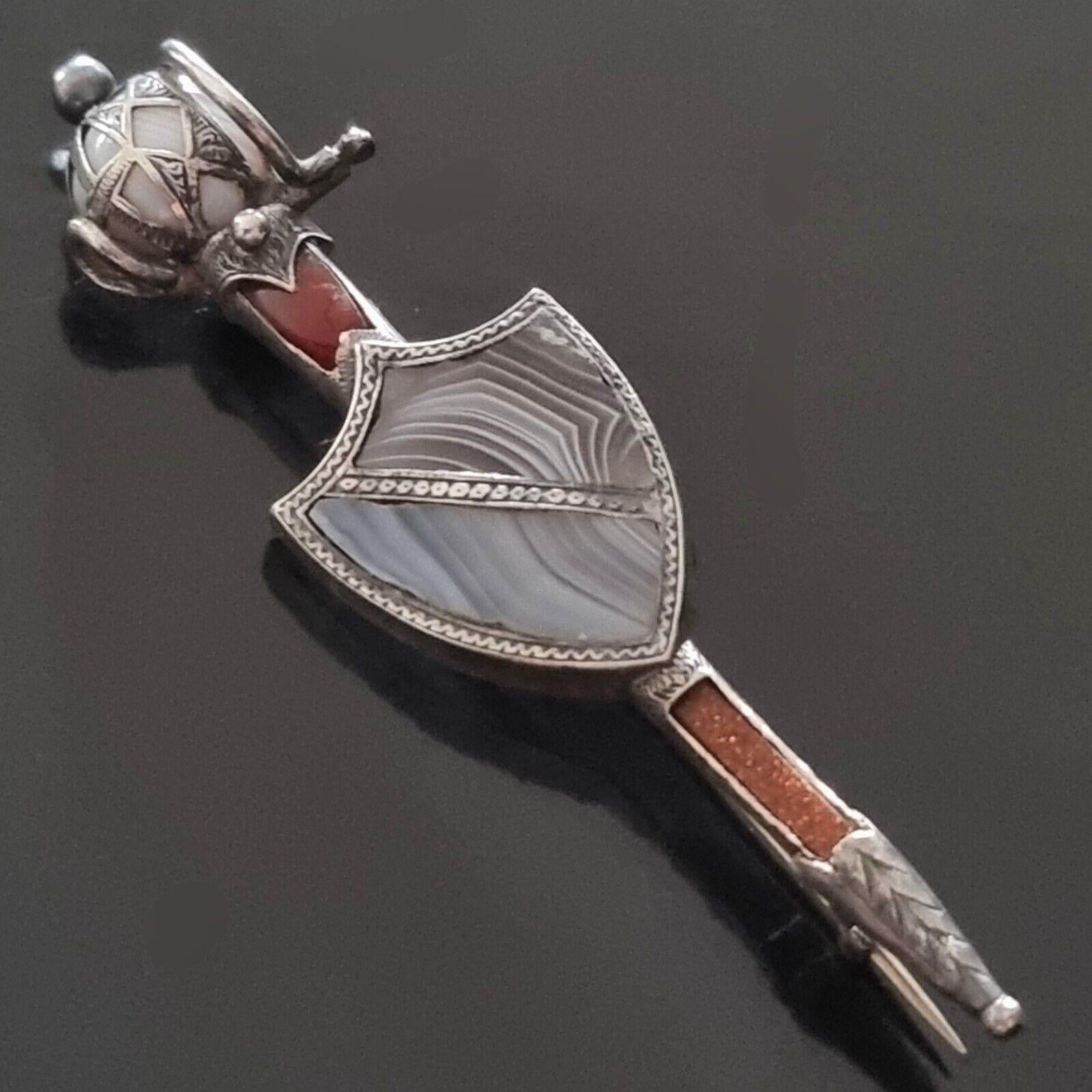 Antique Scottish SWORD and SHIELD BROOCH in Silver,
Victorian Scottish silver brooch,
19th century natural stones,
collector's item, rare,
maker's marks of the time,
dimensions 8 x 2 cm, weight 9.9 g,
example: similar item sold on 1stDIBS (see last
