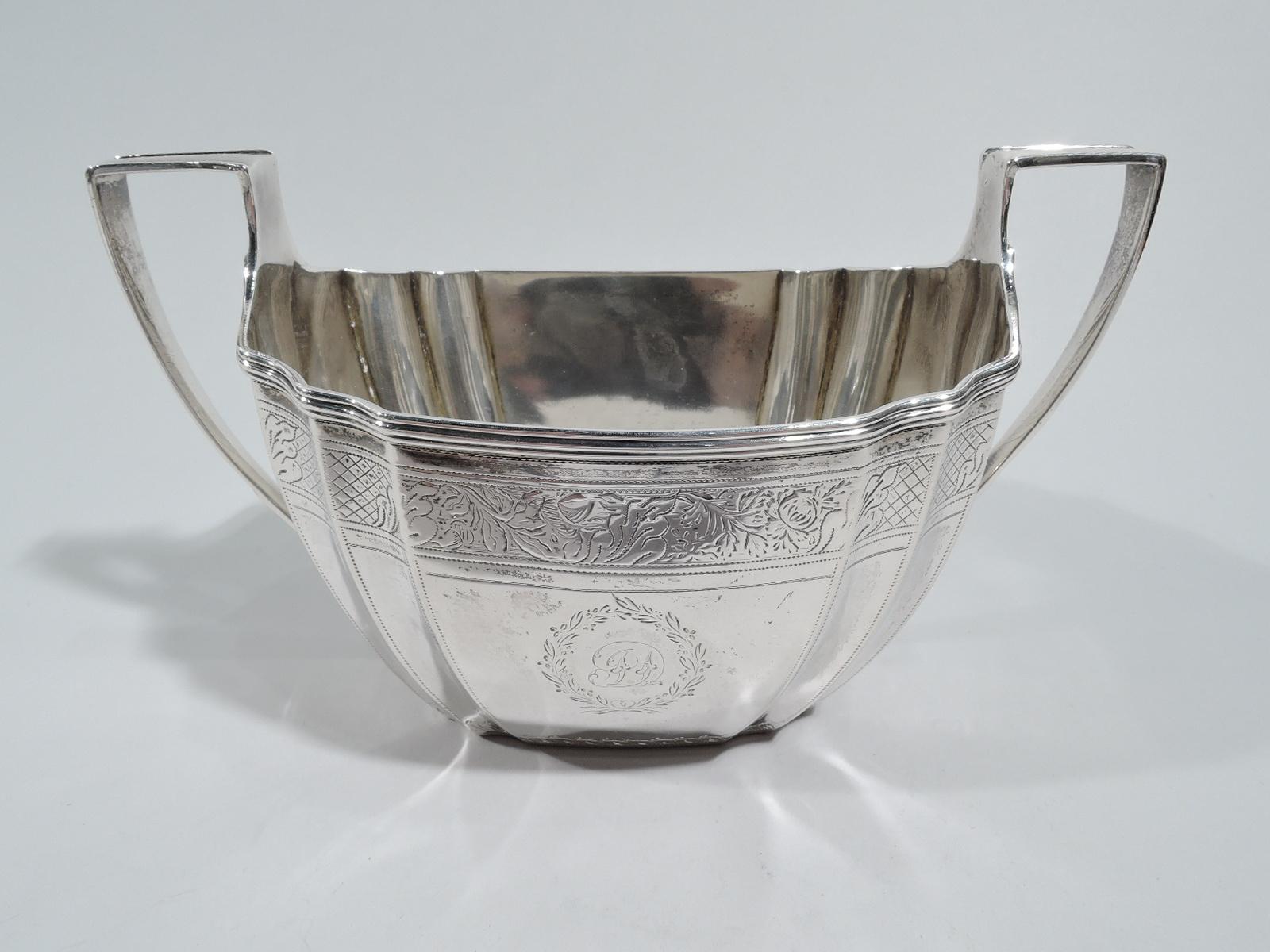 George III sterling silver sugar. Made by McHattie & Fenwick in Edinburgh in 1804. Tapering and curved sides with corner flutes and high scroll bracket handles. Engraved ornamental borders and 2 wreath frames of which one engraved with script