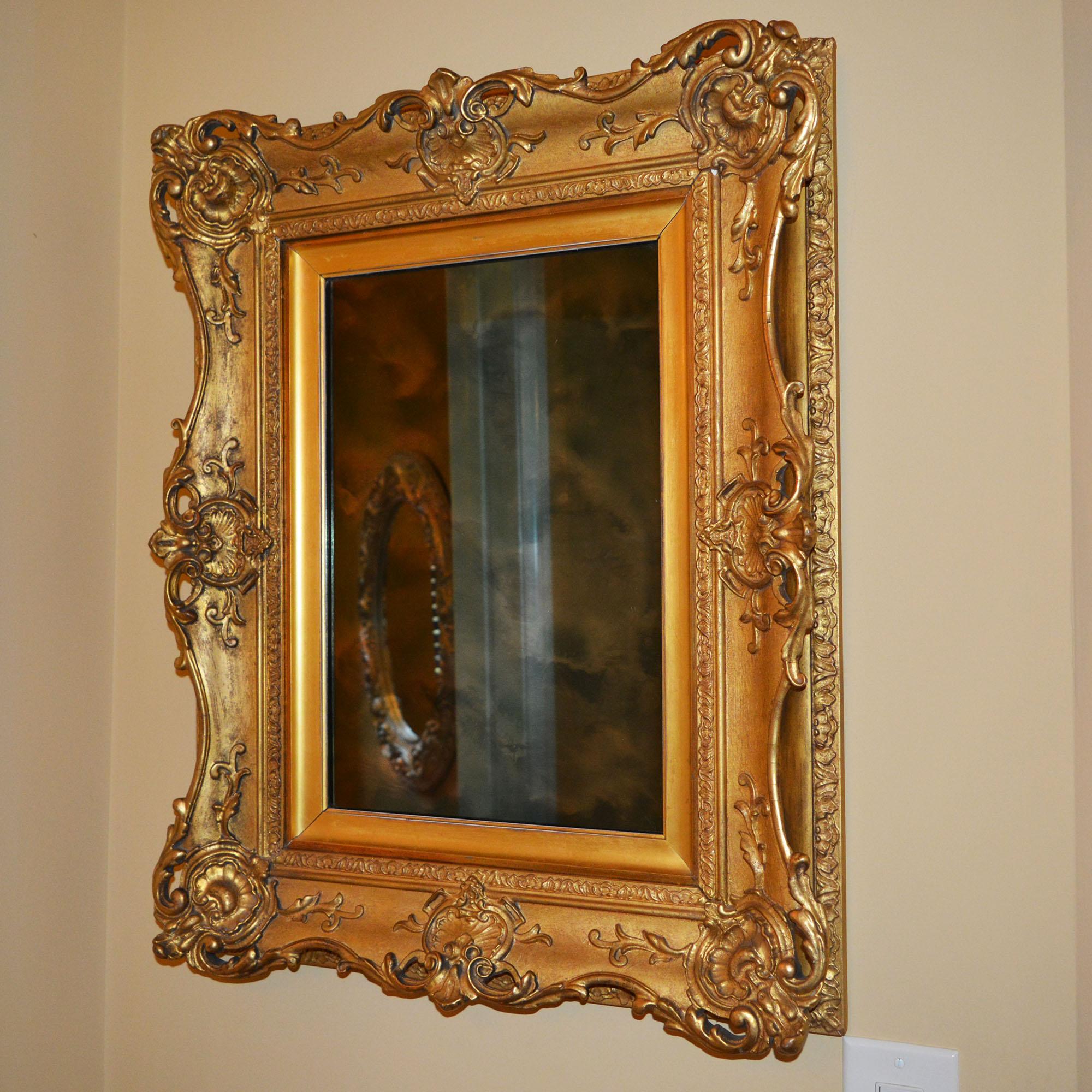 This is an antique wall mirror has painted gilt gesso frame has a beautiful ghosted effect across the mirror. The impressive frame is in wonderful shape. The work of Daniel Miller as the carver and gilder is documented on the back. Daniel Miller