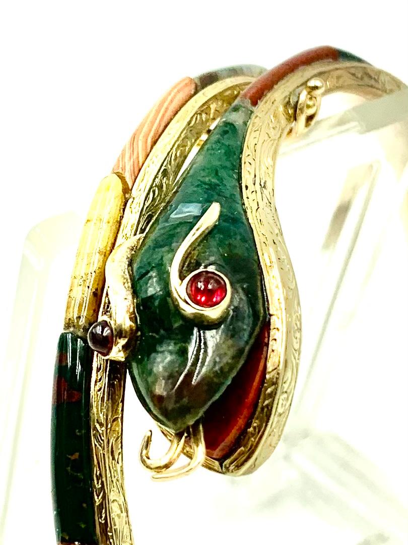 Exceptional and rare antique Scottish snake bracelet in finely engraved 14 karat yellow gold, set with bloodstone, carnelian, blue striated agate, banded agate, red, pink, yellow and green agate, ruby eyes, carnelian mouth. This bracelet is truly a