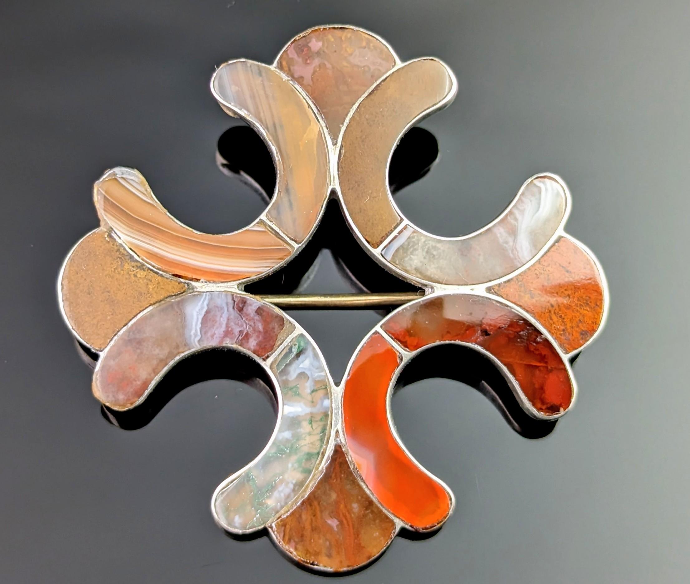 We love this unusual antique, Victorian era Scottish agate and silver Celtic cross brooch.

It has such a unique shape and design made up of smooth polished sections of various different agates, some in half circle, horseshoe like shapes which give
