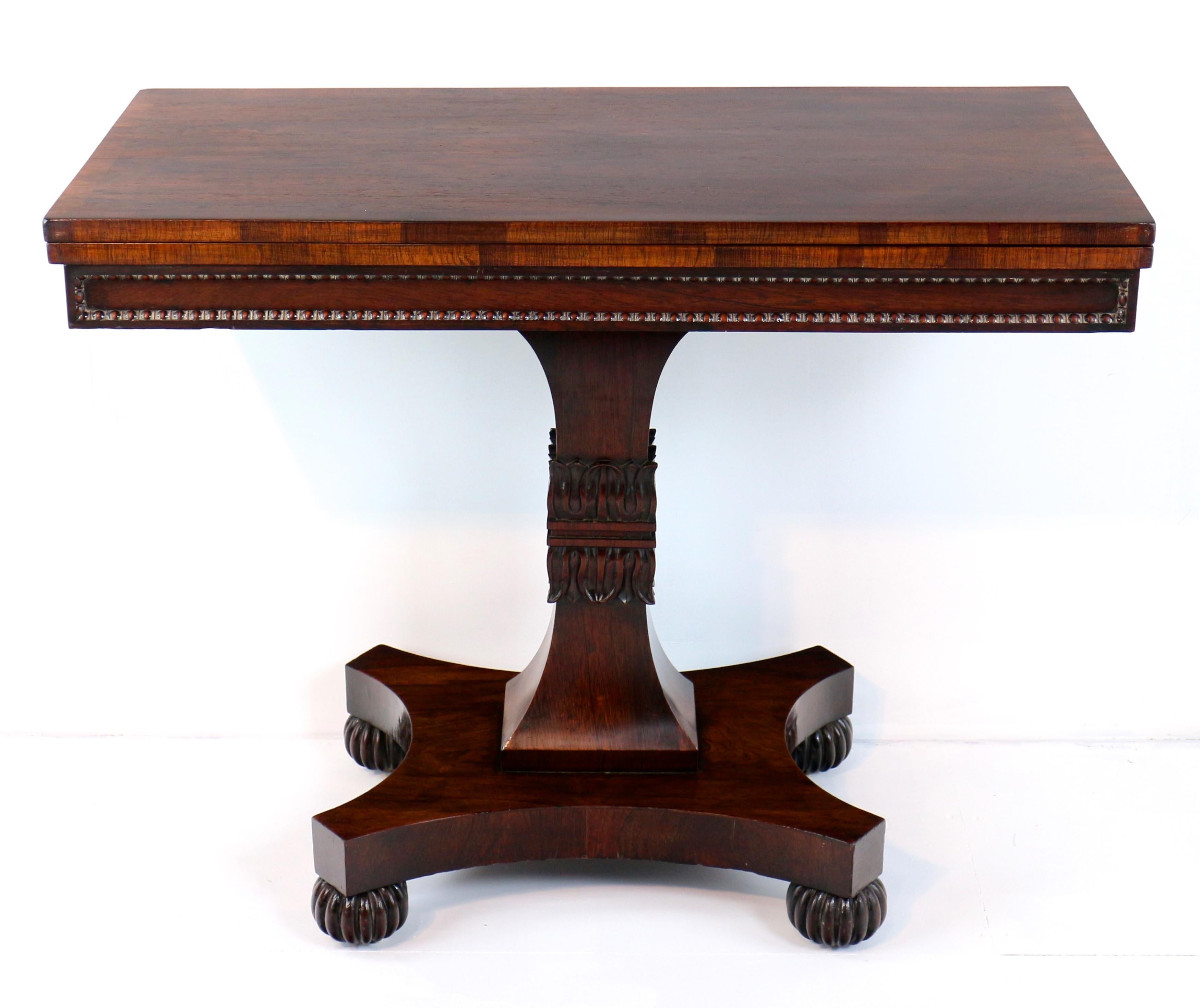 A Scottish Regency rosewood tea table, circa 1820, attributed to William Trotter of Edinburgh. The rectangular crossbanded top above a frieze with typically Scottish sunken panels with bead moulding to all sides, on a waisted and lotus-clasped