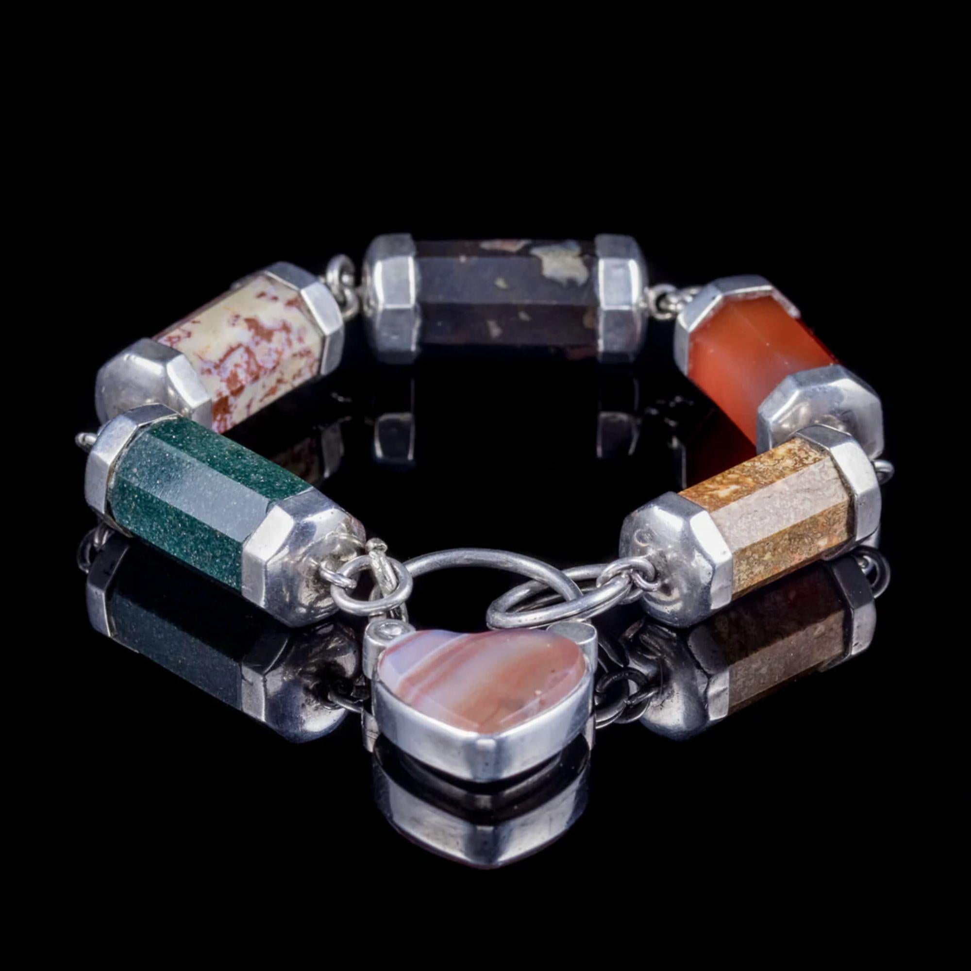 A wonderful antique Scottish bracelet from the late Victorian era made up of colourful barrel agate links held in silver settings. Each Agate is unique and boasts various earthy colours and patterned layers which are naturally formed, earning it the