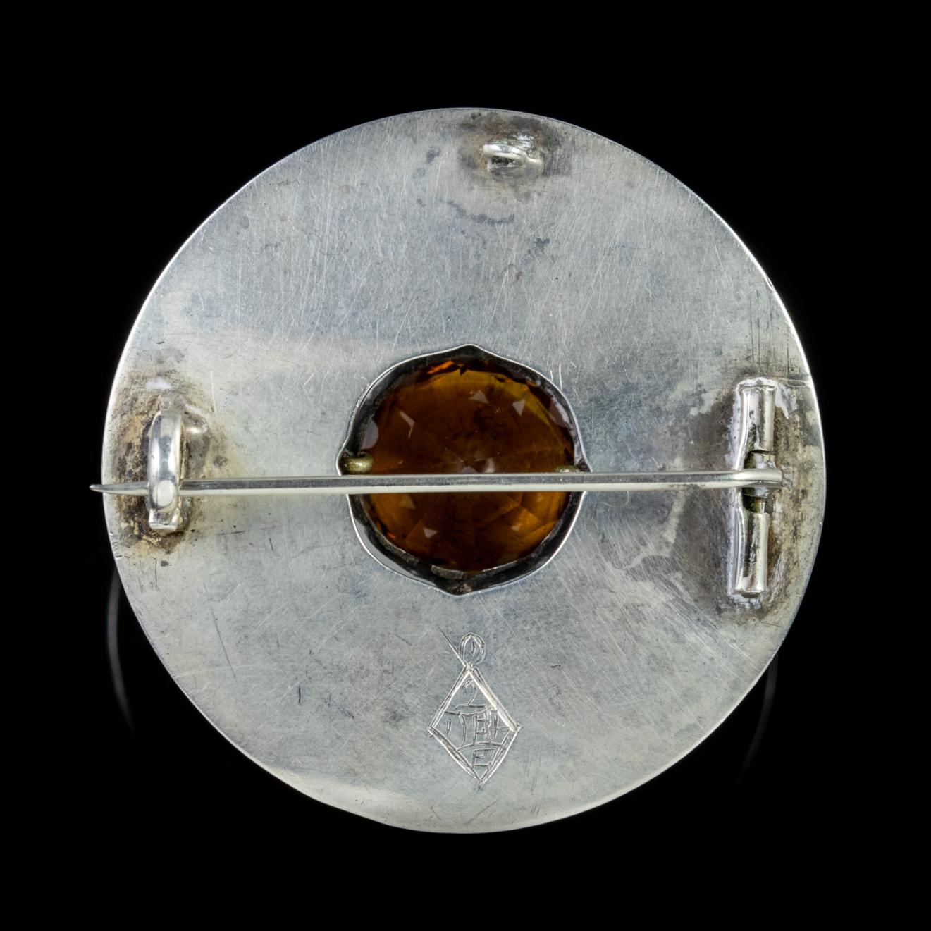 This beautiful Scottish Victorian brooch is crafted around a large Cairngorm, with rings of green and orange Agate radiating outwards.

The Cairngorm stones are sourced from the Cairngorm mountains in Scotland and have a lovely treacle coloured hue