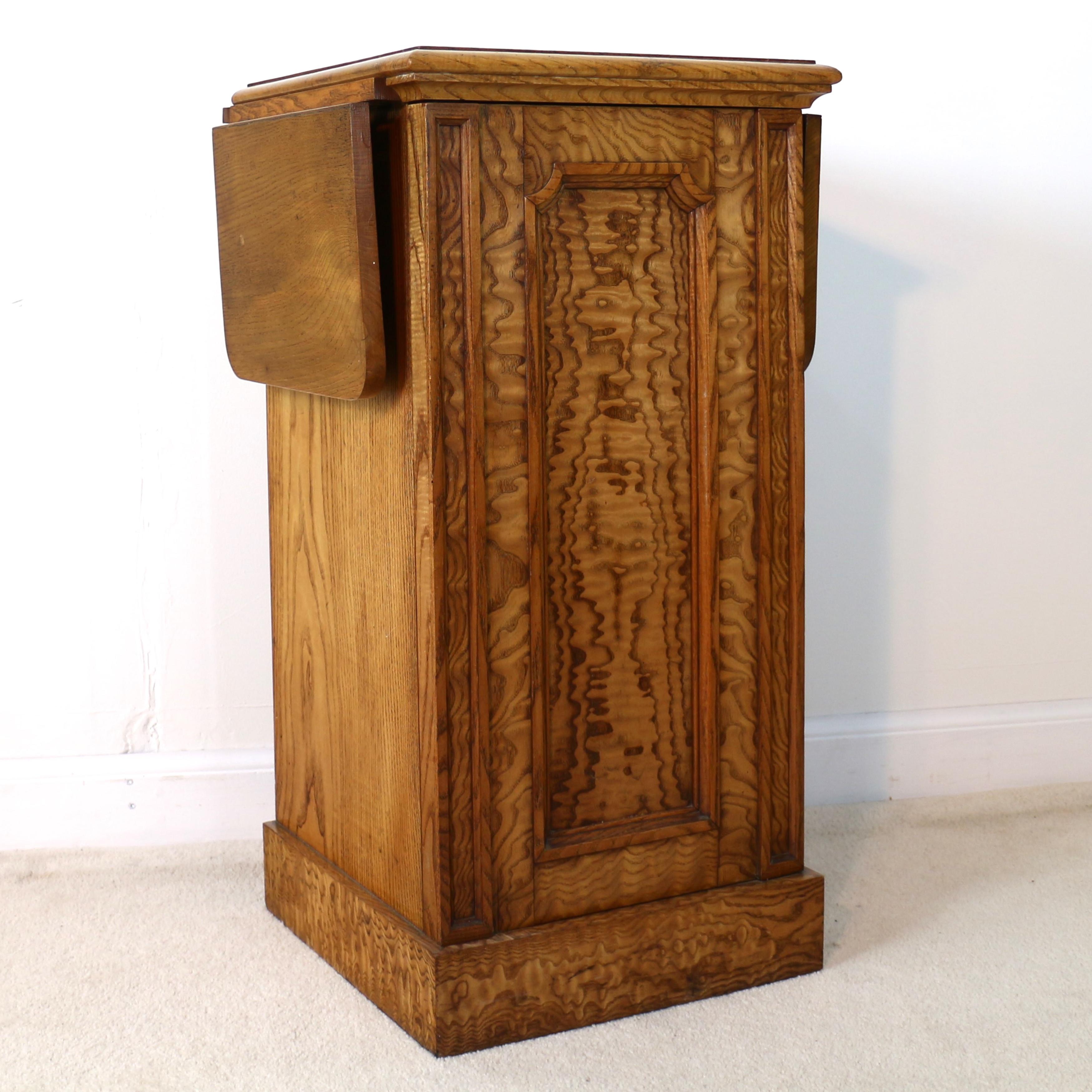 An unusual Scottish William IV figured elm bedside cabinet or pot cupboard dating to circa 1830. The square top with a double moulded edge above a front displaying narrow panelled edges flanking a fielded panelled door with re-entrant corners and on