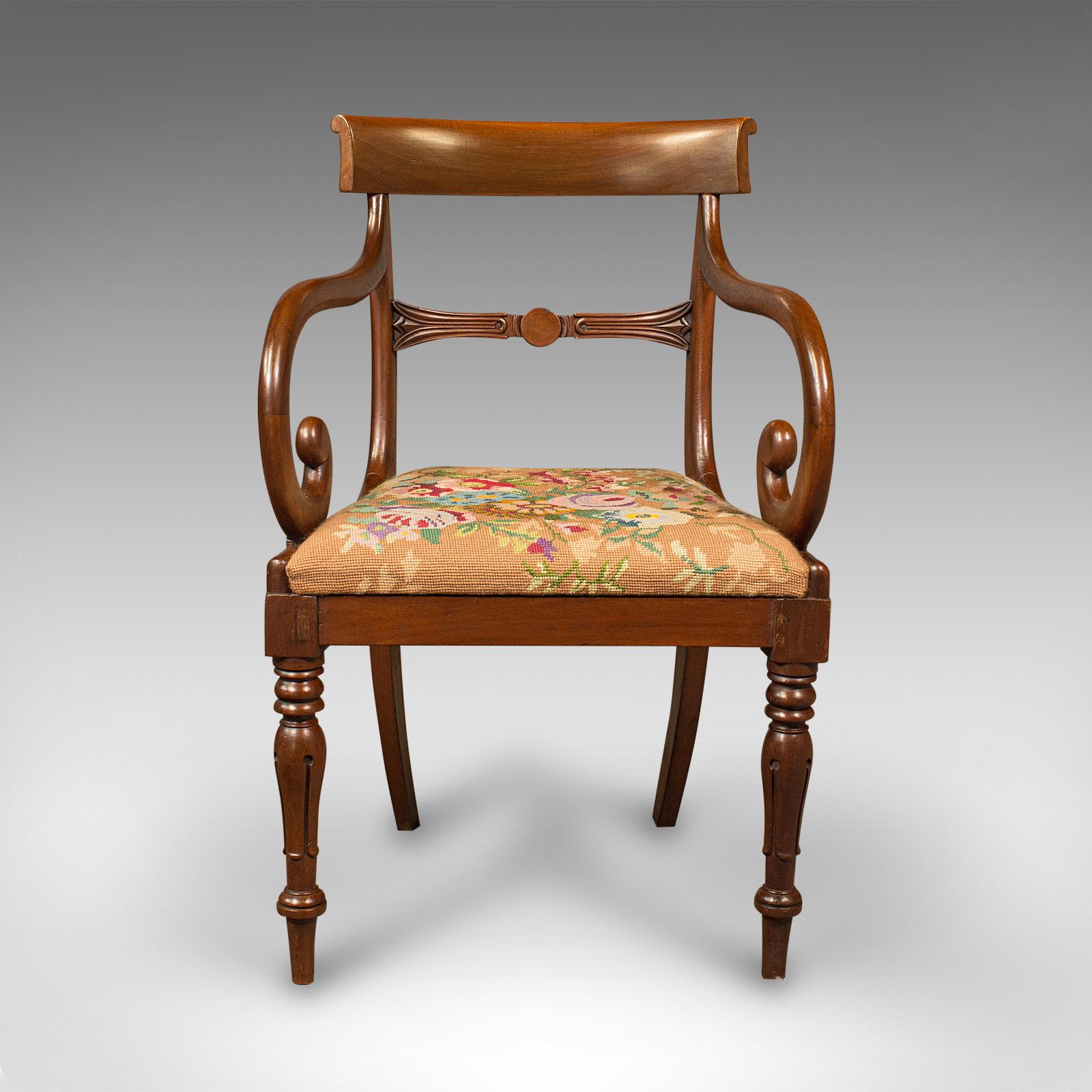 This is an antique scroll arm chair. An English, mahogany armchair with needlepoint upholstery, dating to the Regency period, circa 1830.

Striking serpentine form with an attractive finish
Displaying a desirable aged patina and in good order