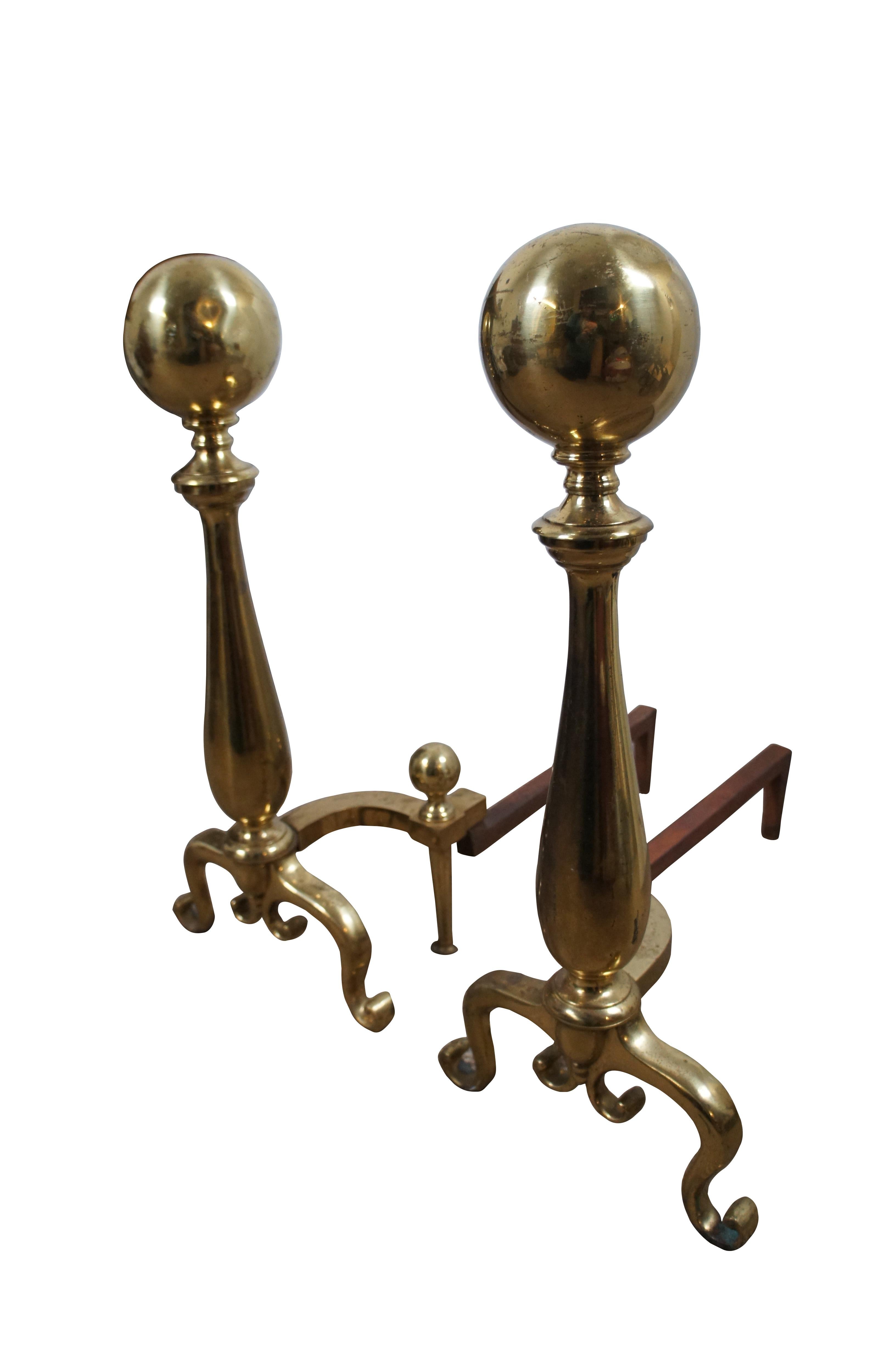 Large antique brass fireplace andirons featuring Colonial styling with scrolled feet and large cannonball tops . Iron legs marked 2GB.

Dimensions:
10.75