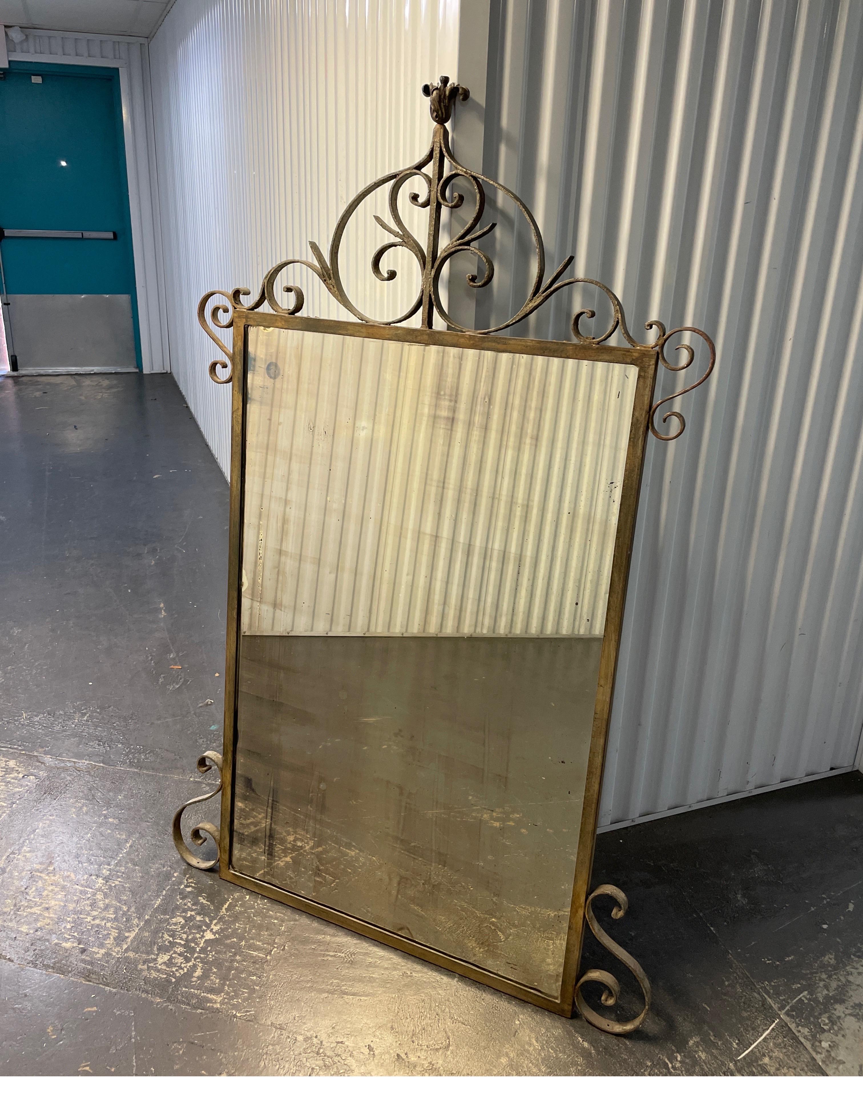 Large antique wrought iron mirror with scrolled adornments on top & sides. Original patina & mirror plate.