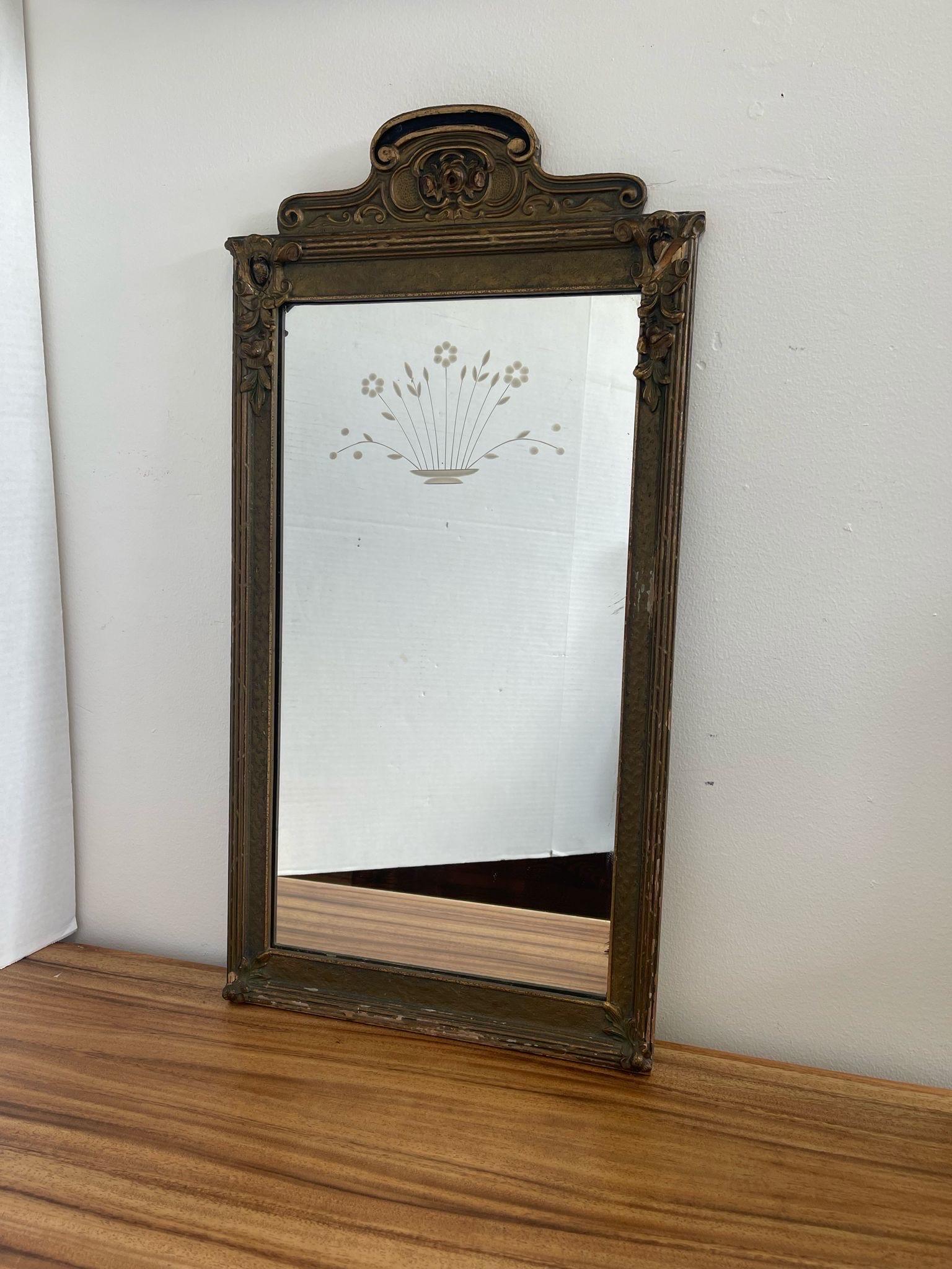 Ornate detailing on the wooden frame with arched top. Beautiful Petina and Aging to the frame and Mirror. Possibly circa1920. No Makers mark. Vintage Condition Consistent with Age as Pictured.

Dimensions. 14 W ; 1 D ; 29 H