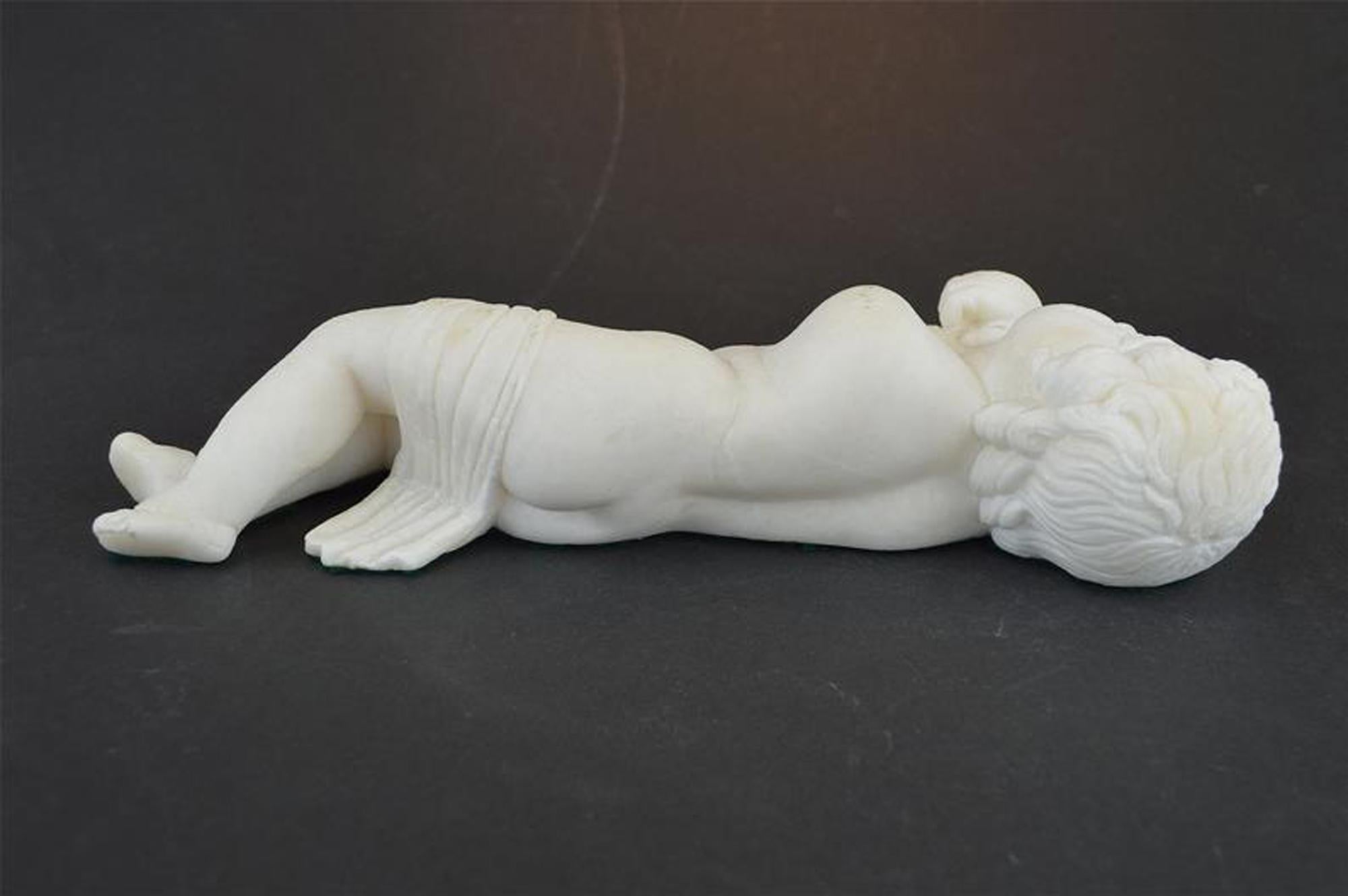 A beautiful antique sculpture of a sleeping cherub. Hand carved from white marble and dating from circa 1900, probably of Italian origin. The piece has a weathered finish, it is in good condition with two repairs to the hand and arm. Measures: