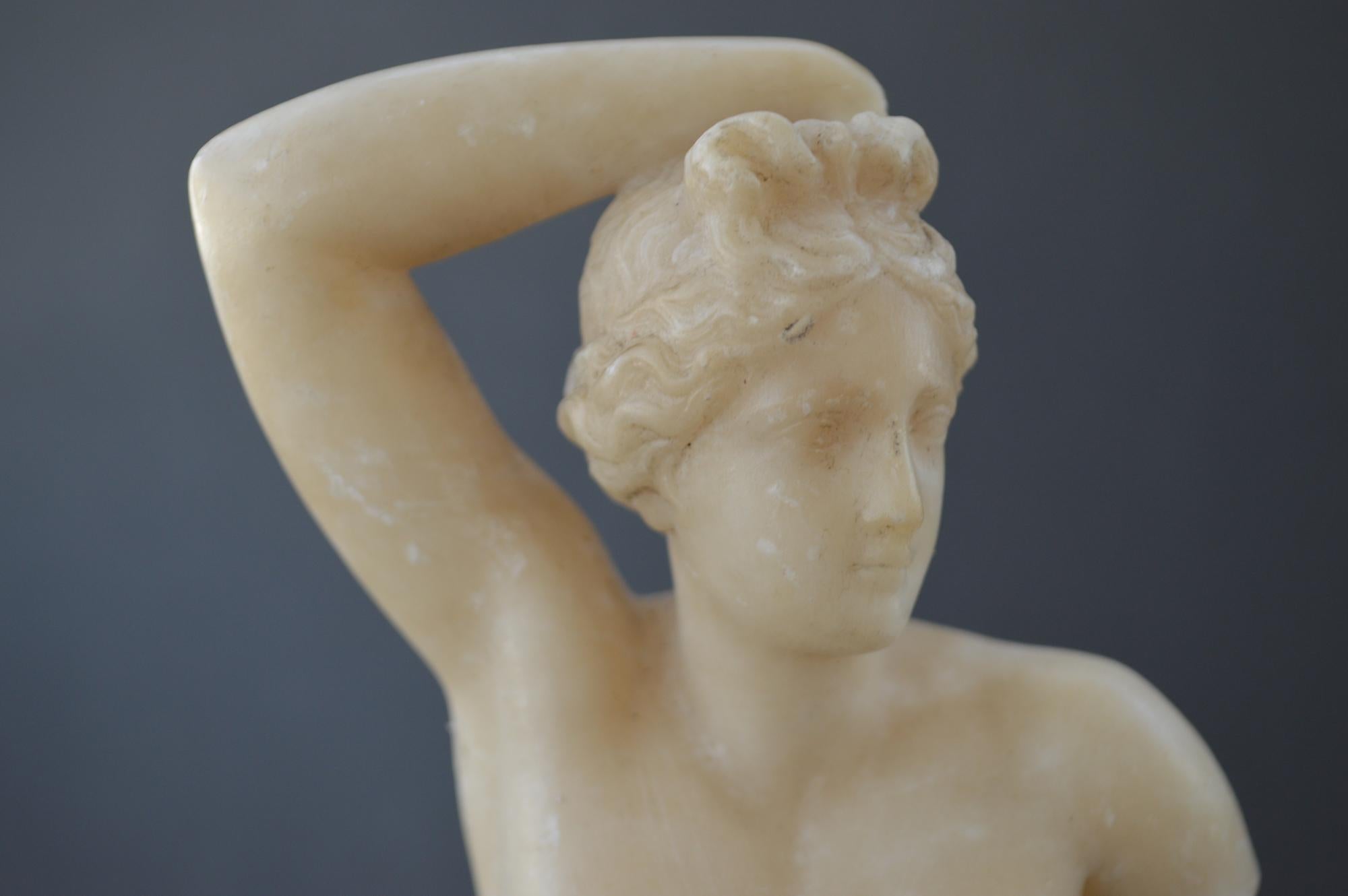 Extremely decorative antique sculpture of classical male torso. Hand carved from alabaster and standing on a black marble base and dating from circa 1900.

Probably made in Italy or France. 35.5cms tall, 10.2cms wide and 10.2cms deep. 14 inches