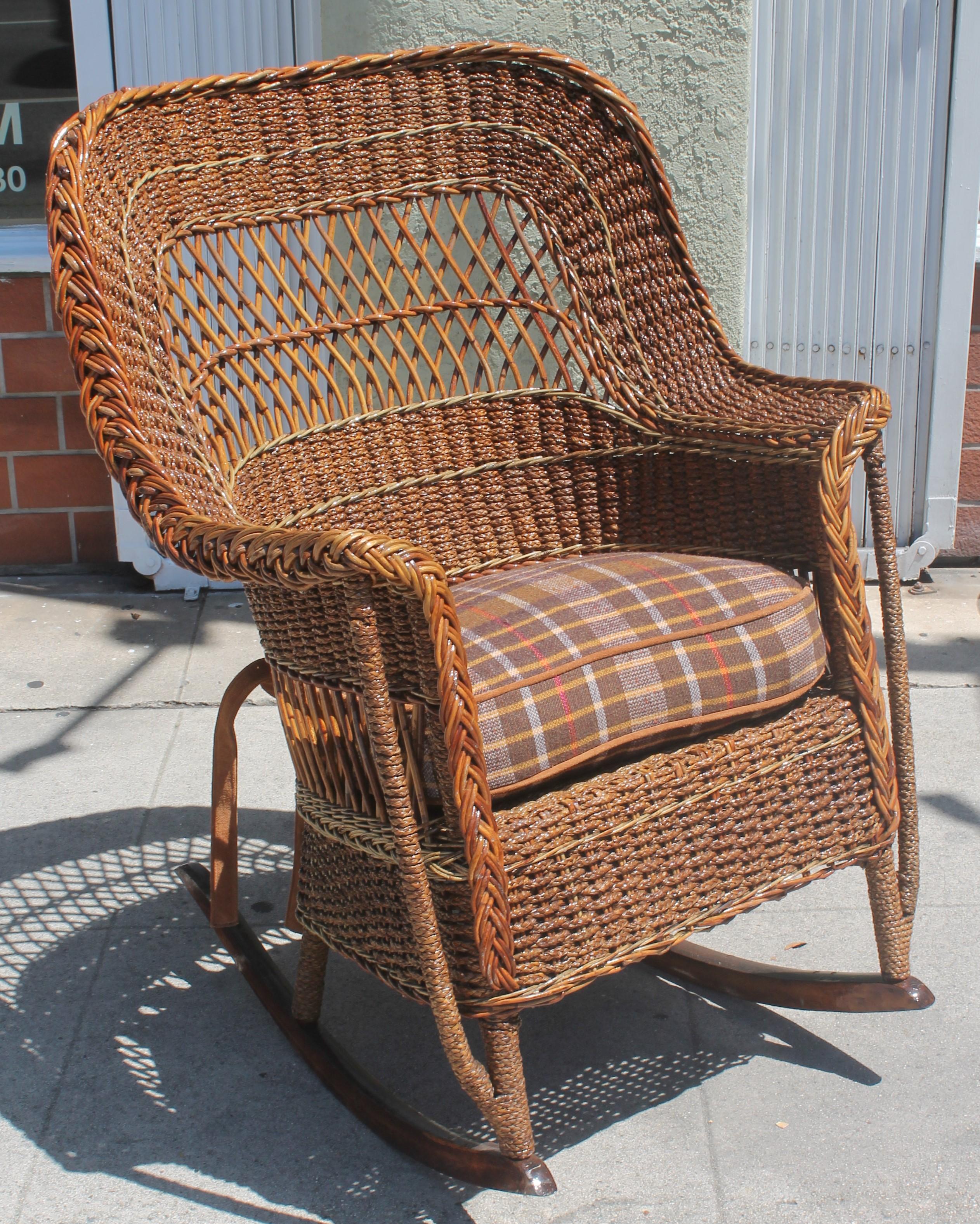 This amazing large wicker and sea grass rocking chair is from the early 20th century and in fantastic condition. It comes with a cushion as well made from a vintage blanket.