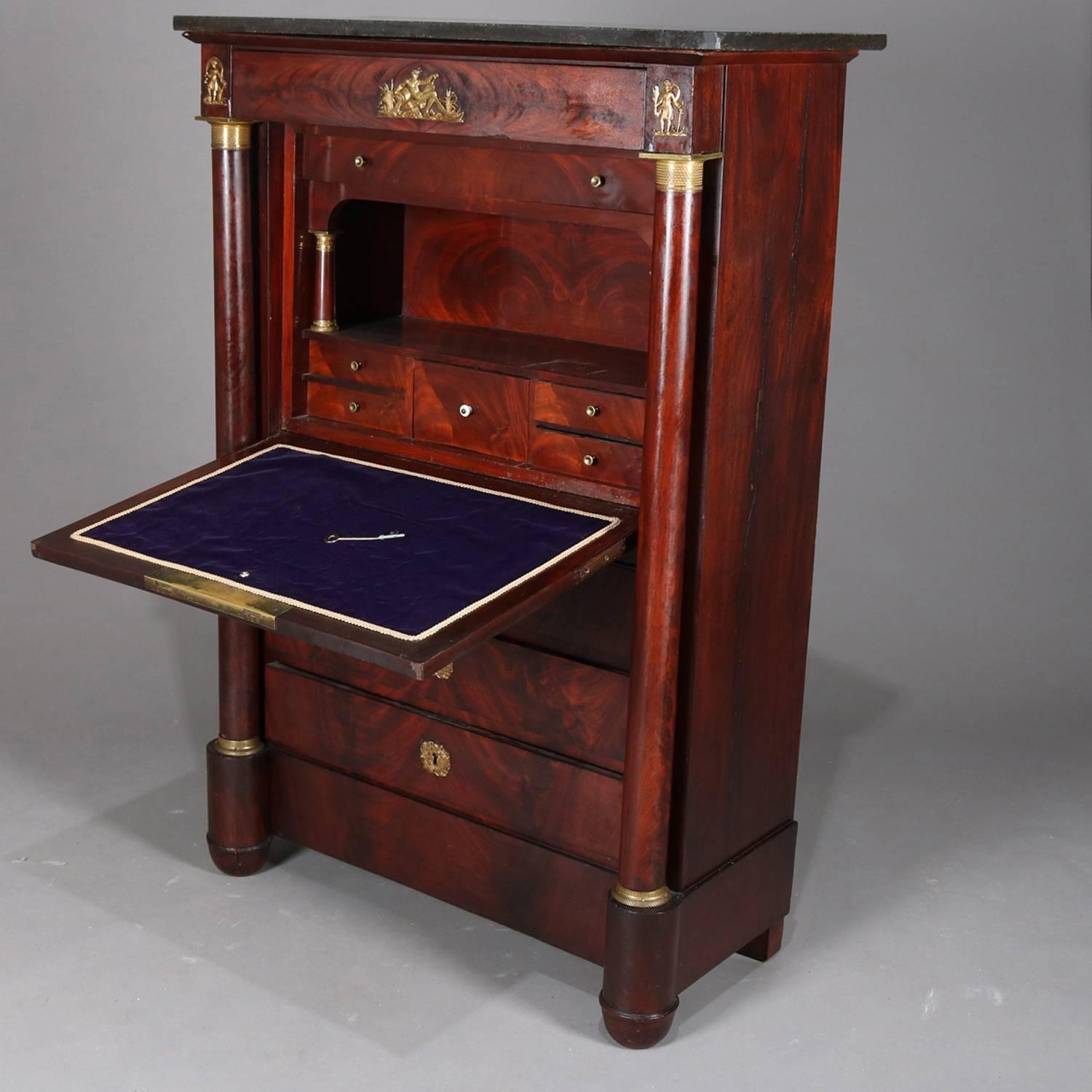 Antique Second Empire French secrétaire à abattant features flame mahogany construction with long drawer above bookmatched drop front desk opening to writing surface with pigeon holes and small drawers above three long drawers and flanked by full