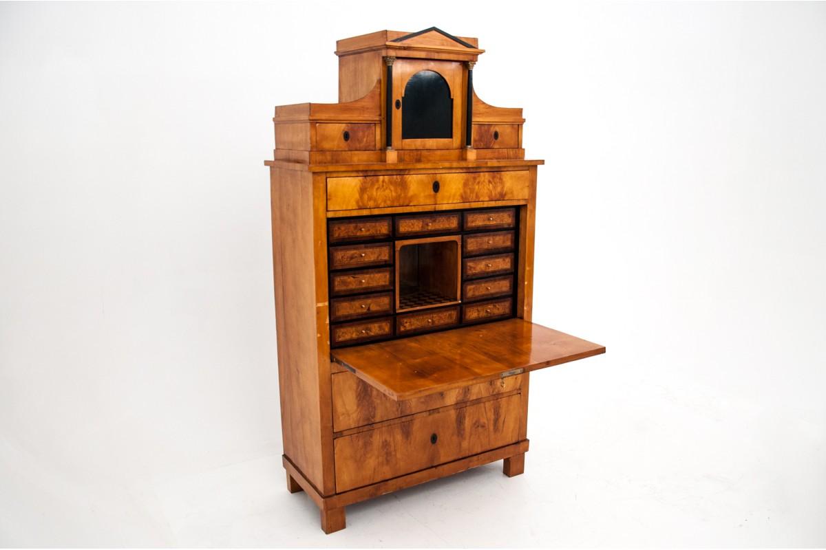 The unique, birch secretary was created circa 1820 in Scandinavia. Empire style furniture has numerous drawers and storage compartments, the hinged flap opens as a desk top. The secretary is decorated with a subtle black tortie band - unique.