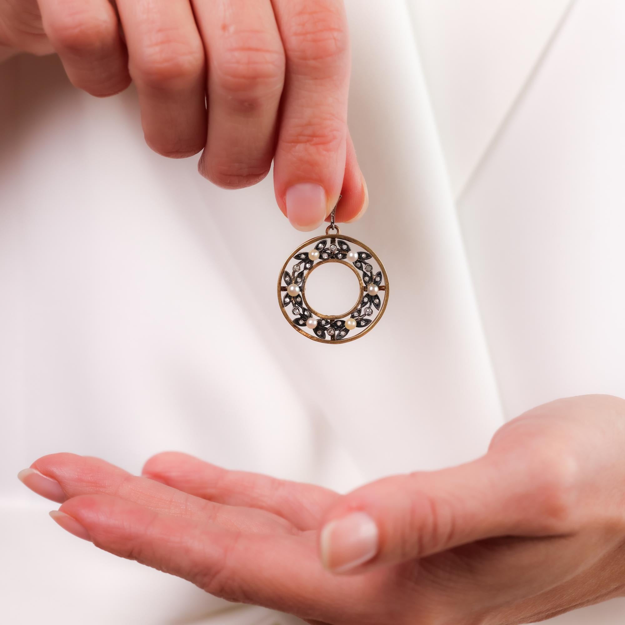 This antique pendant showcases luminous seed pearls and sparkling rose cut diamonds, elegantly crafted in 18k yellow gold and silver for timeless charm.

Center stone: 6 seed pearls 
Size: Approximately 2.89mm-2.55mm
Accent stone: 30 rose cut