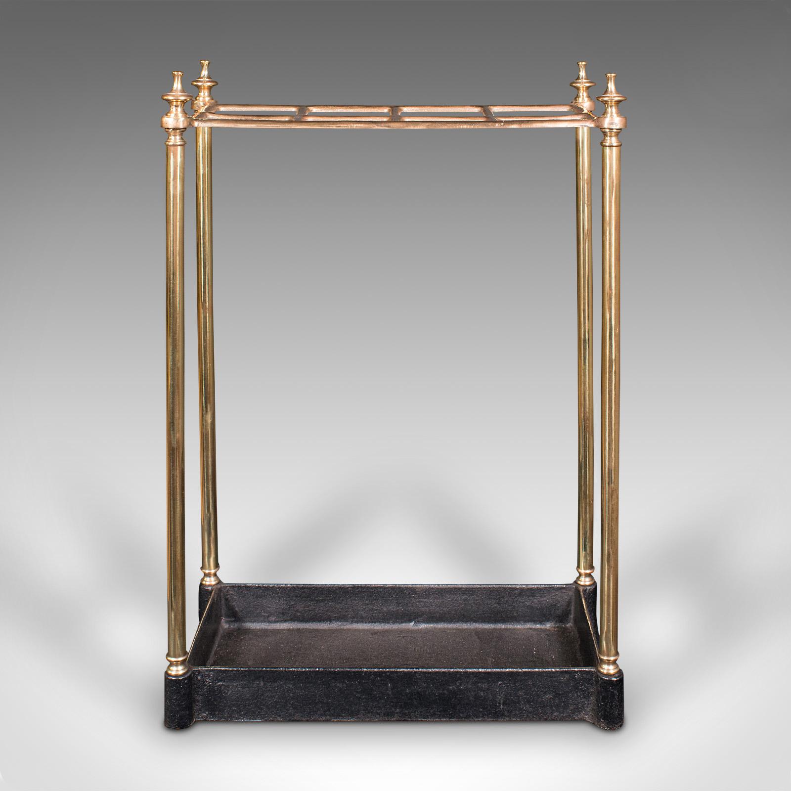 This is an antique segmented stick stand. An English, brass and cast iron hallway rack, dating to the late Victorian period, circa 1900.

Distinctive eight section stick stand with appealing colour
Displays a desirable aged patina