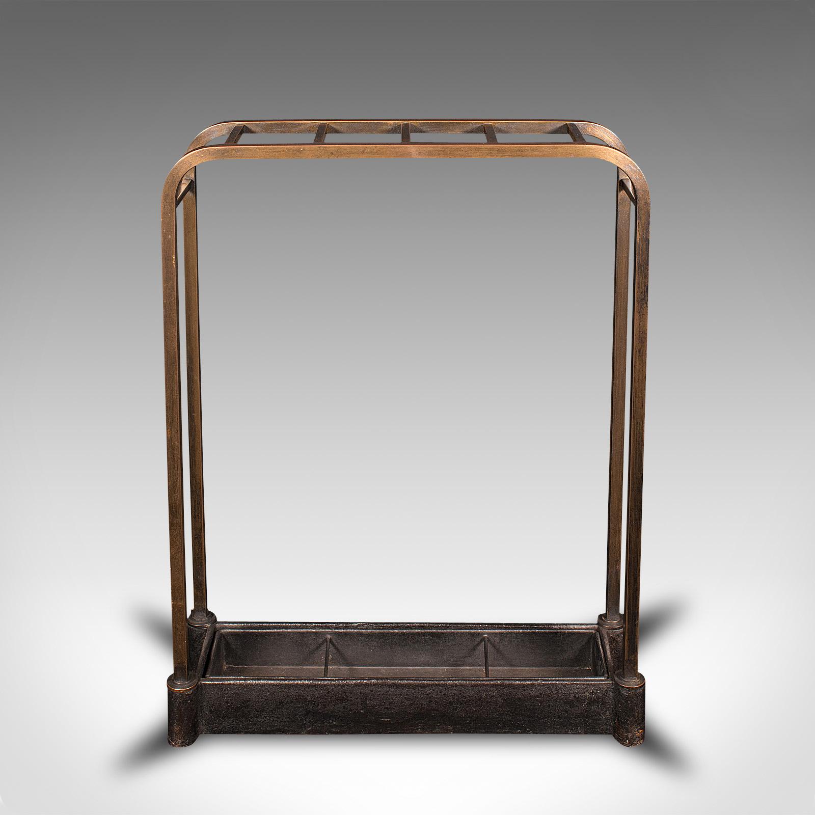 This is an antique segmented stick stand. An English, brass and cast iron umbrella rack with drip tray, dating to the late Victorian period, circa 1880.

Appealing and discrete, ideal for the entrance hall
Displays a desirable aged patina and in