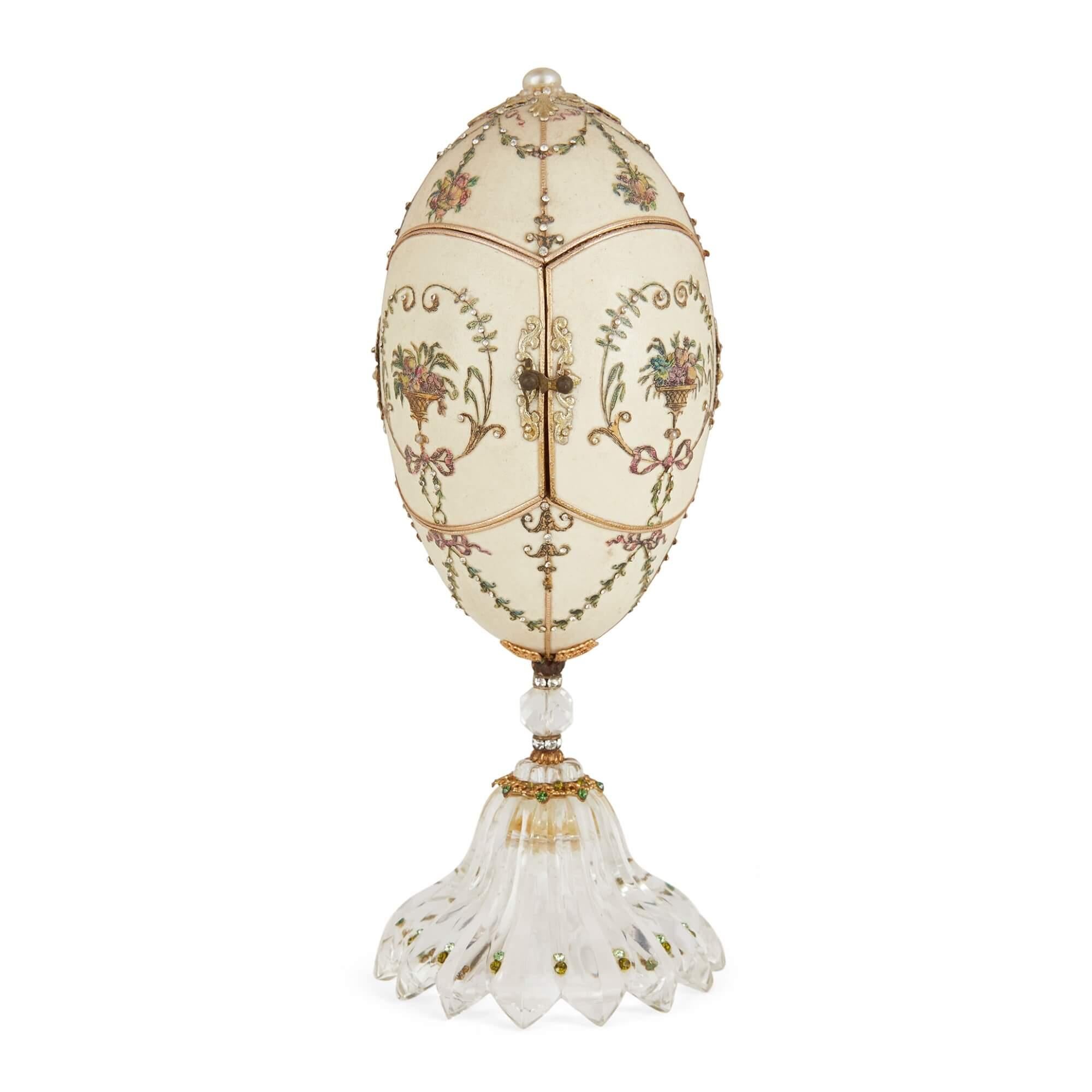 Antique semi-precious stone and silver-gilt egg model
Continental, Late 19th Century
Height 19cm, diameter 8cm

This superb decorative egg model is inset with a charming scene on the interior. 

The egg stands on a flared base of fluted rock