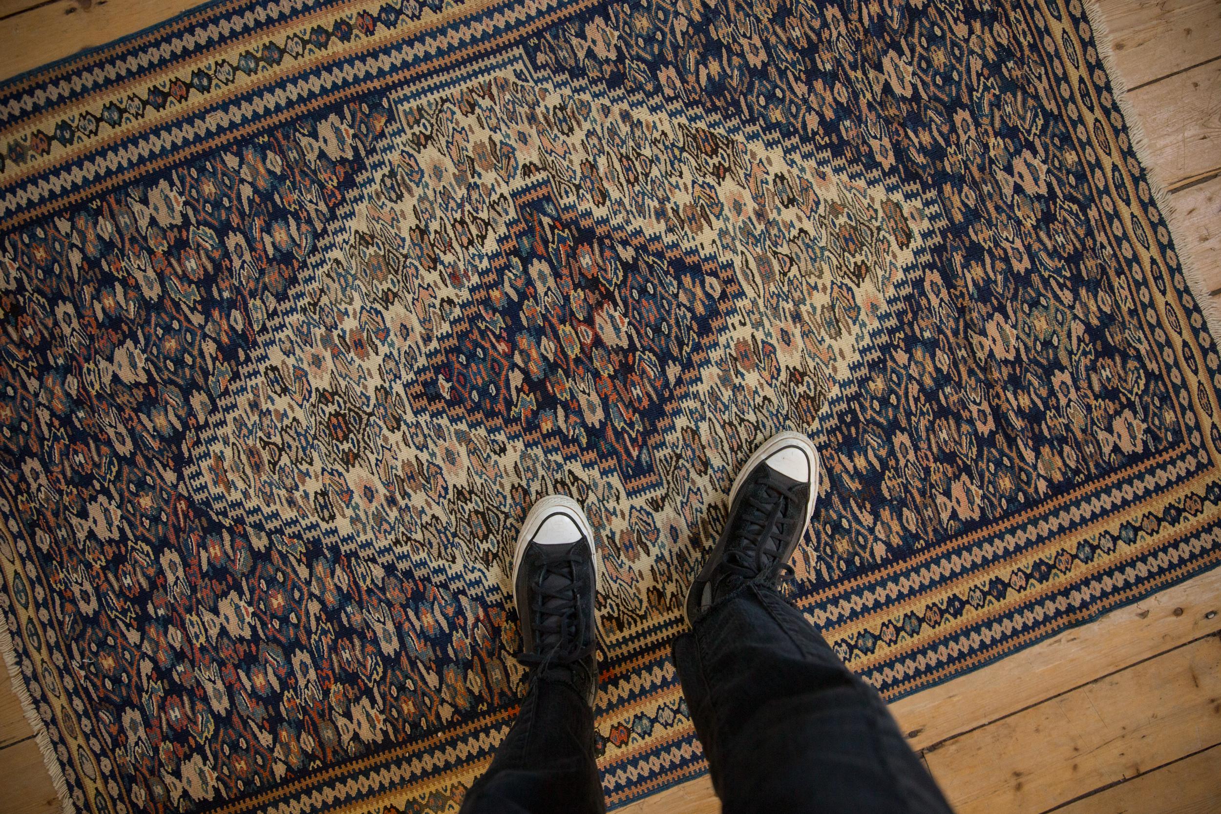 :: Classic center medallion Senneh with concentric overlays in stepped relief. A highly intricate rug with fantastic contrast and implied movement throughout. Colors and shades include: Ivory, navy blue, camel, sand, pale saffron, and a hint of pale