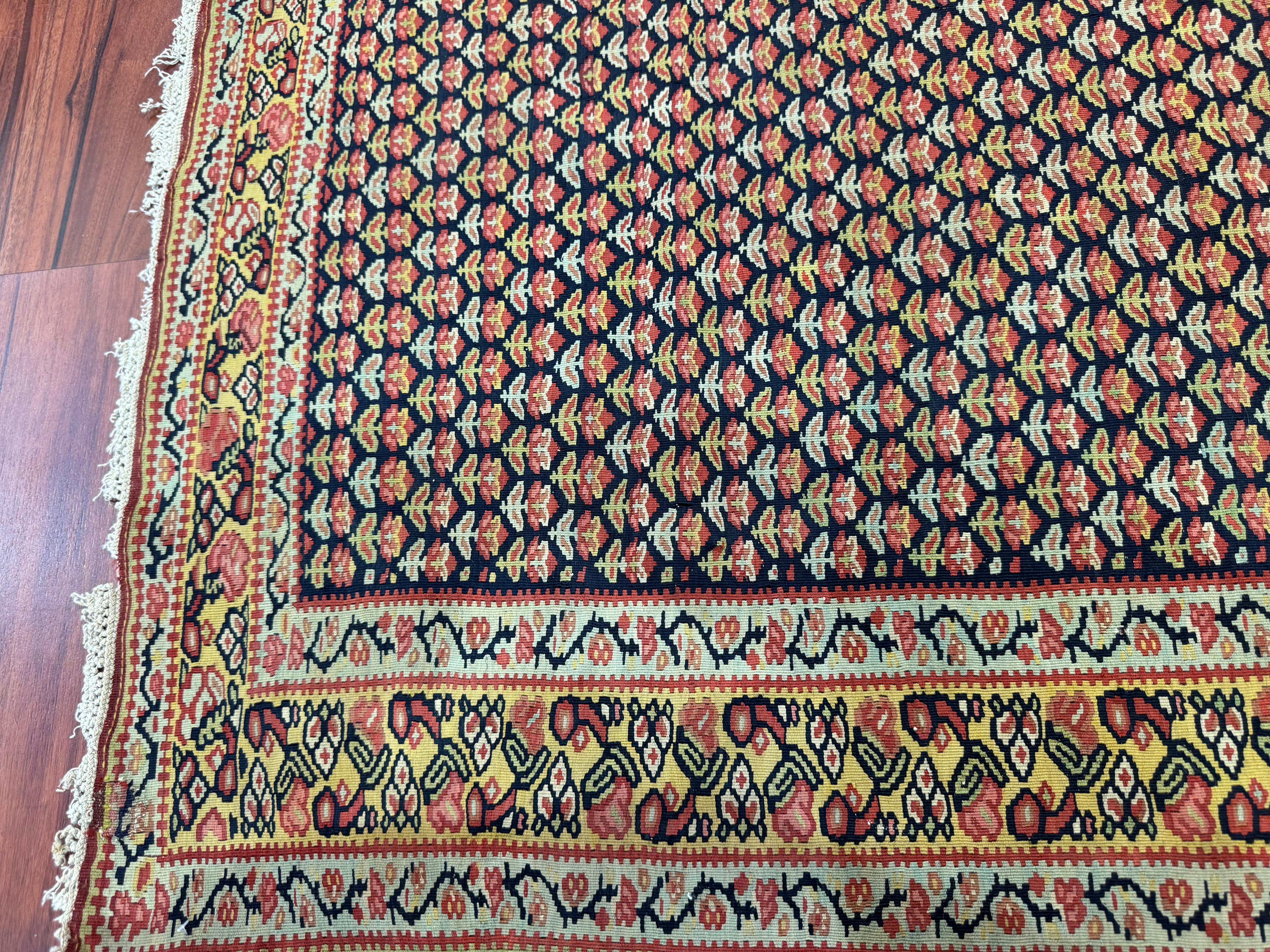 A stunning Antique Senneh Kilim rug that measures in at 3’6” width and 4’10” length. These rugs are known for their excellent compositions and fine weaves. This Rug originated from Iran in the early 1900s and is in excellent condition considering
