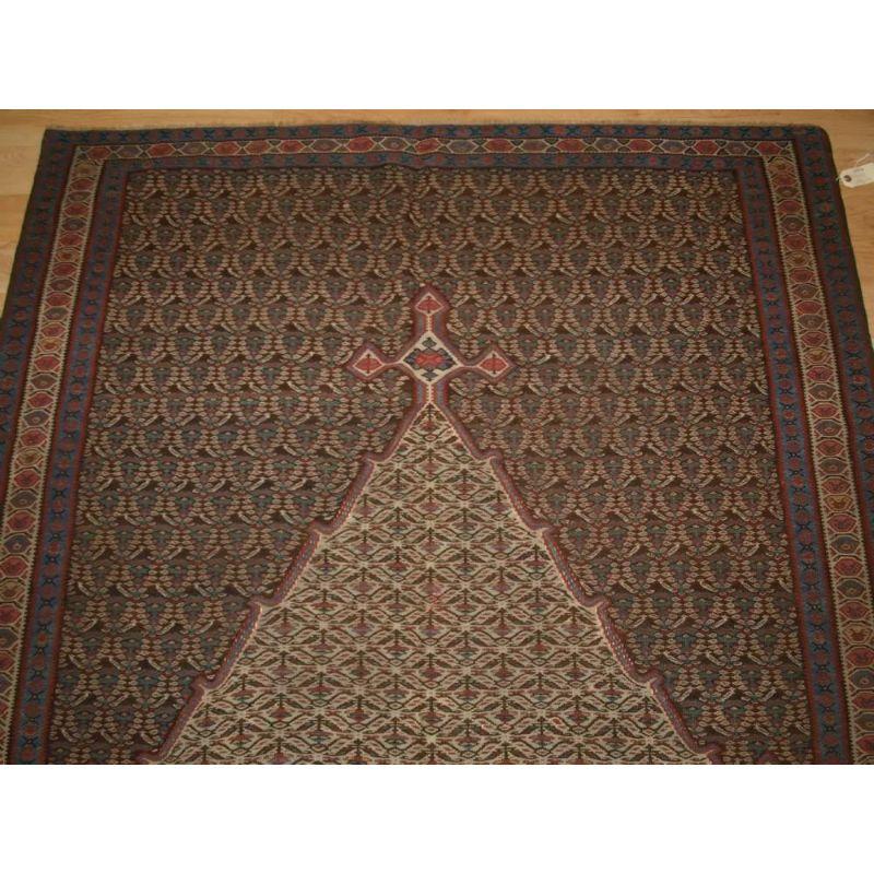 A fine Senneh kilim with soft colours and a beautiful design with a large medallion surrounded by very well drawn boteh. The kilim has a wonderful soft colour palette.

Excellent condition with very slight even wear. A fine but strong kilim