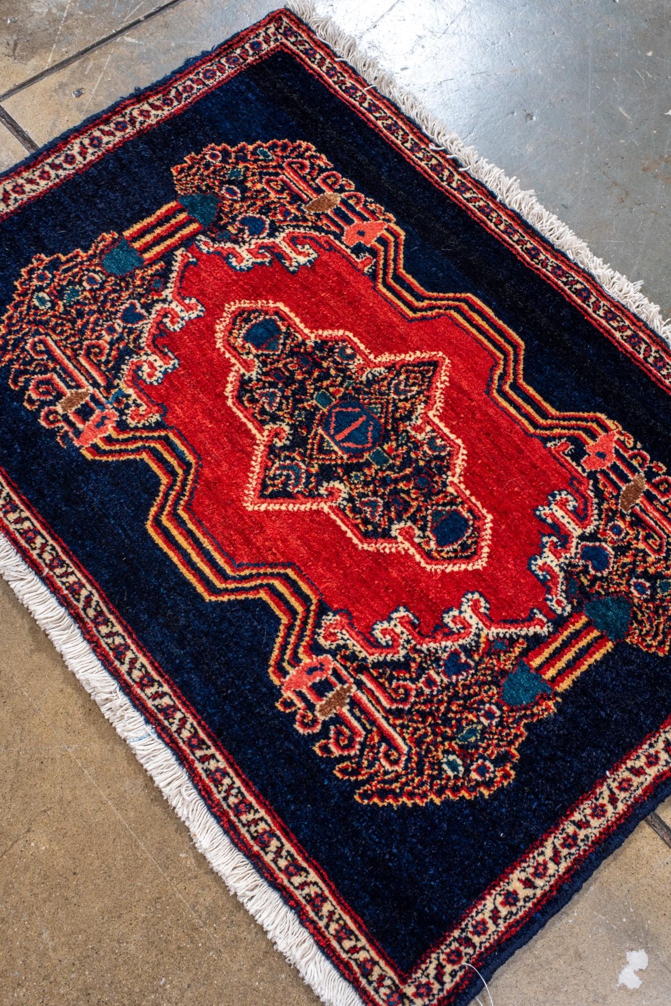 Persian Antique Senneh Mat with Dark Blue Field and Red Medallion For Sale