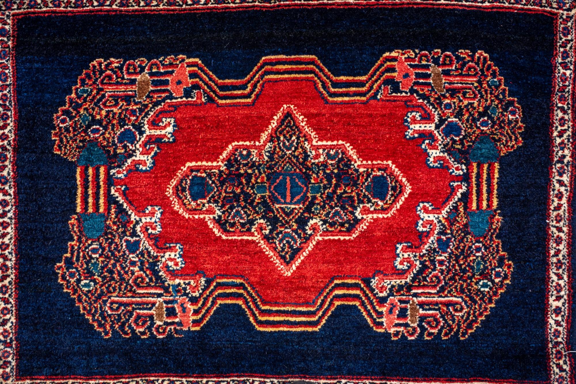 Hand-Knotted Antique Senneh Mat with Dark Blue Field and Red Medallion For Sale