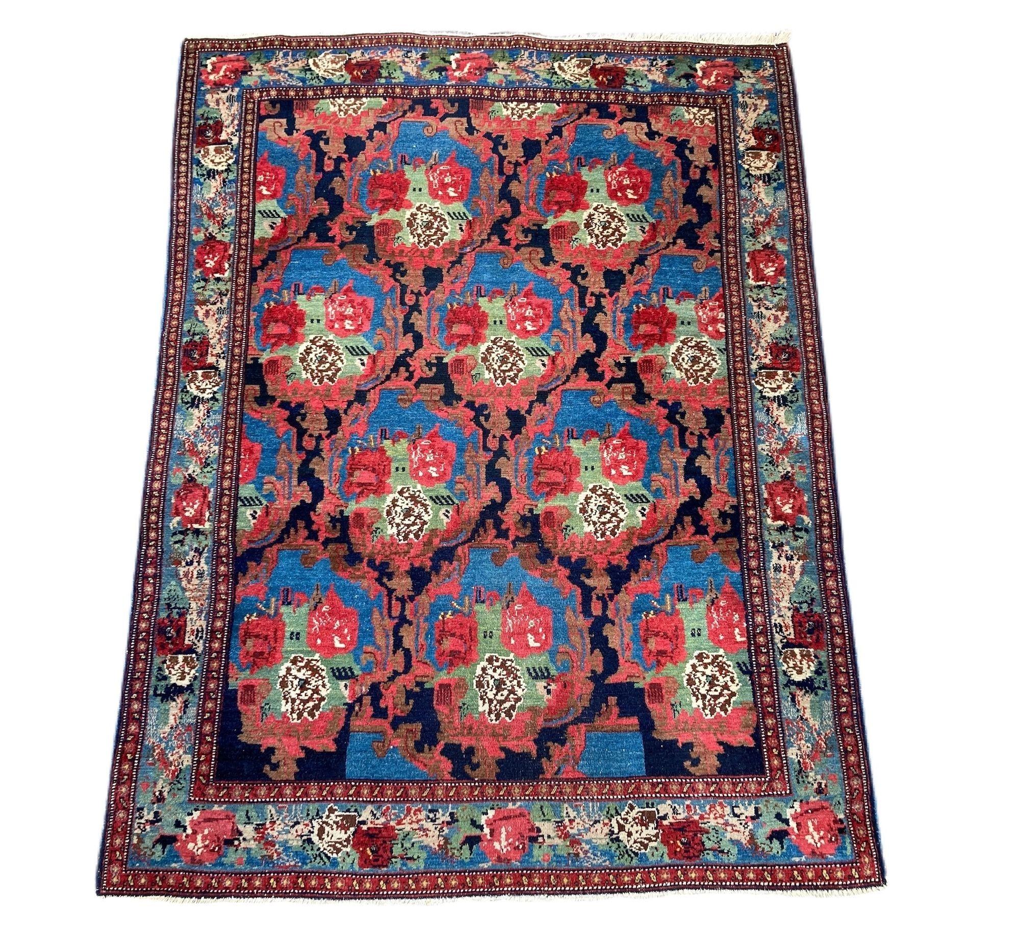 A lovely antique Senneh rug, hand woven circa 1900 featuring a Gol Farang (literally meaning ‘foreign flower’) design on a deep indigo field. Finely woven with great quality wool and wonderful colours of blues, greens and reds.
Size: 1.82m x 1.38m
